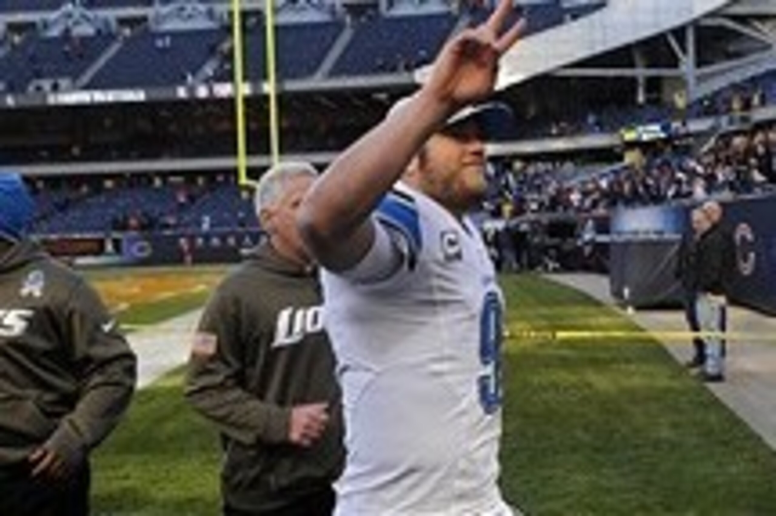 Nov 10, 2013; Chicago, IL, USA;  Detroit Lions quarterback Matthew Stafford (9) waves to fans after the Lions beat the Bears 21-19 at Soldier Field. Mandatory Credit: Matt Marton-USA TODAY Sports