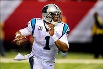 Dec 29, 2013; Atlanta, GA, USA; Carolina Panthers quarterback Cam Newton (1) runs with the ball against the Atlanta Falcons during the second half at the Georgia Dome. The Panthers defeated the Falcons 21-20. Mandatory Credit: Dale Zanine-USA TODAY Sports