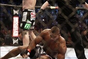 Aug 17, 2013; Boston, MA, USA; Travis Browne (rear) celebrates his win over  Alistair Overeem during a UFC heavyweight match at the TD Garden. Brown won by knockout in one round. Mandatory Credit: Winslow Townson-USA TODAY Sports