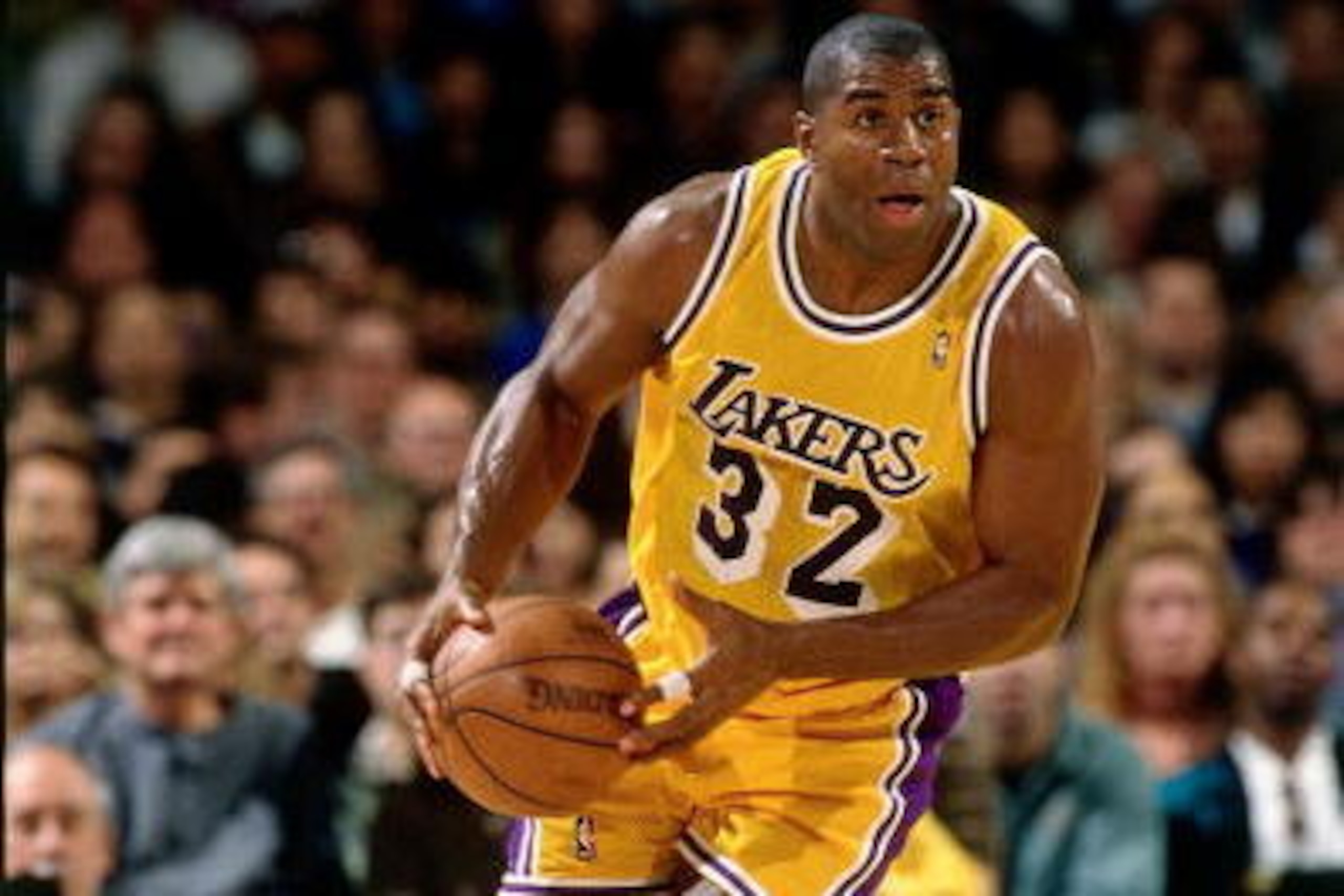 LOS ANGELES - FEBRUARY 4:  Magic Johnson #32 of the Los Angeles Lakers dribbles the ball upcourt against the Utah Jazz during an NBA game at the Staples Center on February 4,1996 in Los Angeles, California.  NOTE TO USER: User expressly acknowledges and a