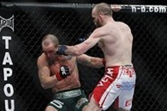 May 25, 2013; Las Vegas, NV, USA; TJ Grant punches Gray Maynard during UFC 160 at the MGM Grand Garden Arena. Mandatory Credit: Gary A. Vasquez-USA TODAY Sports