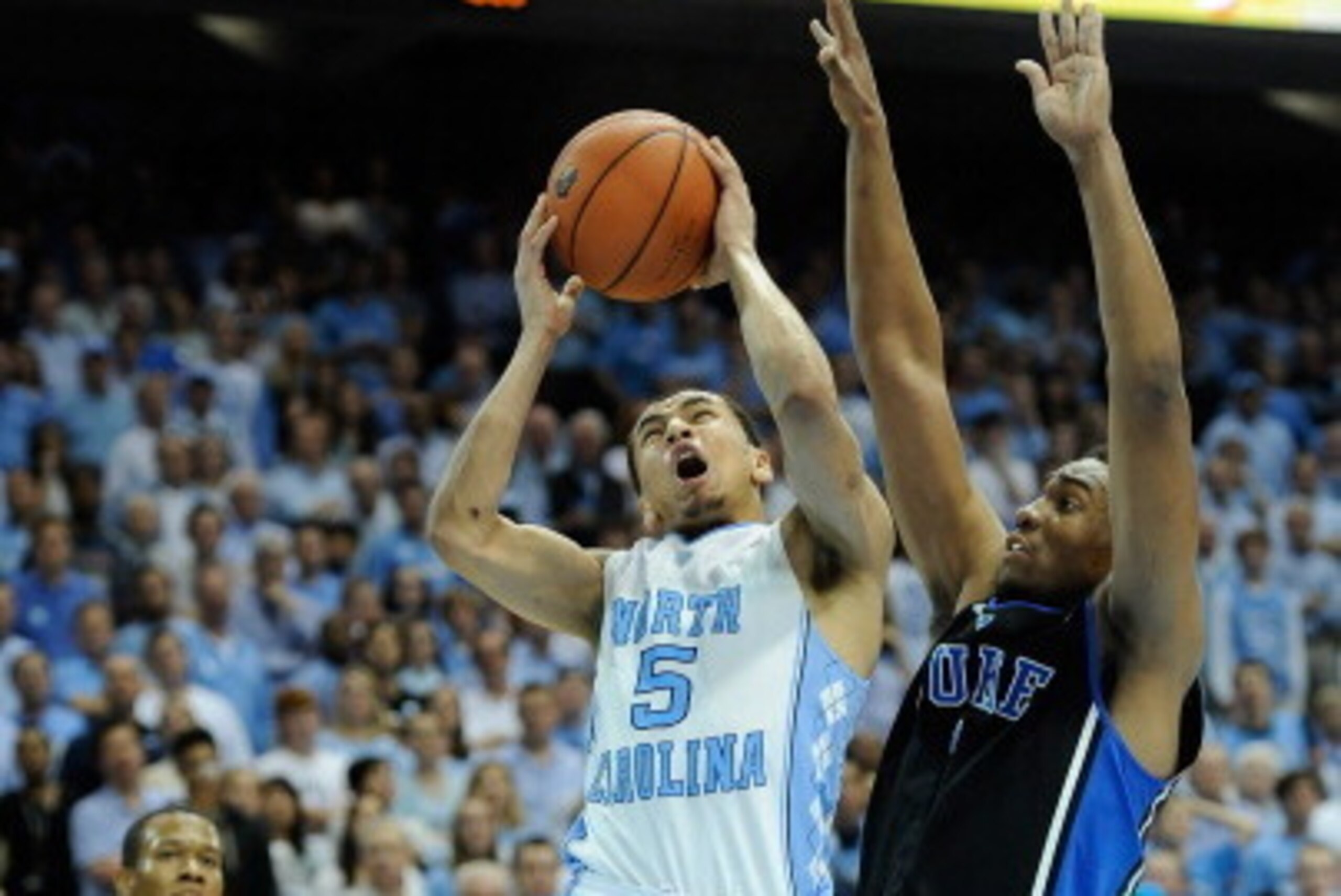 CHAPEL HILL, NC - FEBRUARY 20:  Jabari Parker #1 of the Duke Blue Devils defends a shot by Marcus Paige #5 of the North Carolina Tar Heels during their game at the Dean Smith Center on February 20, 2014 in Chapel Hill, North Carolina. North Carolina won 7