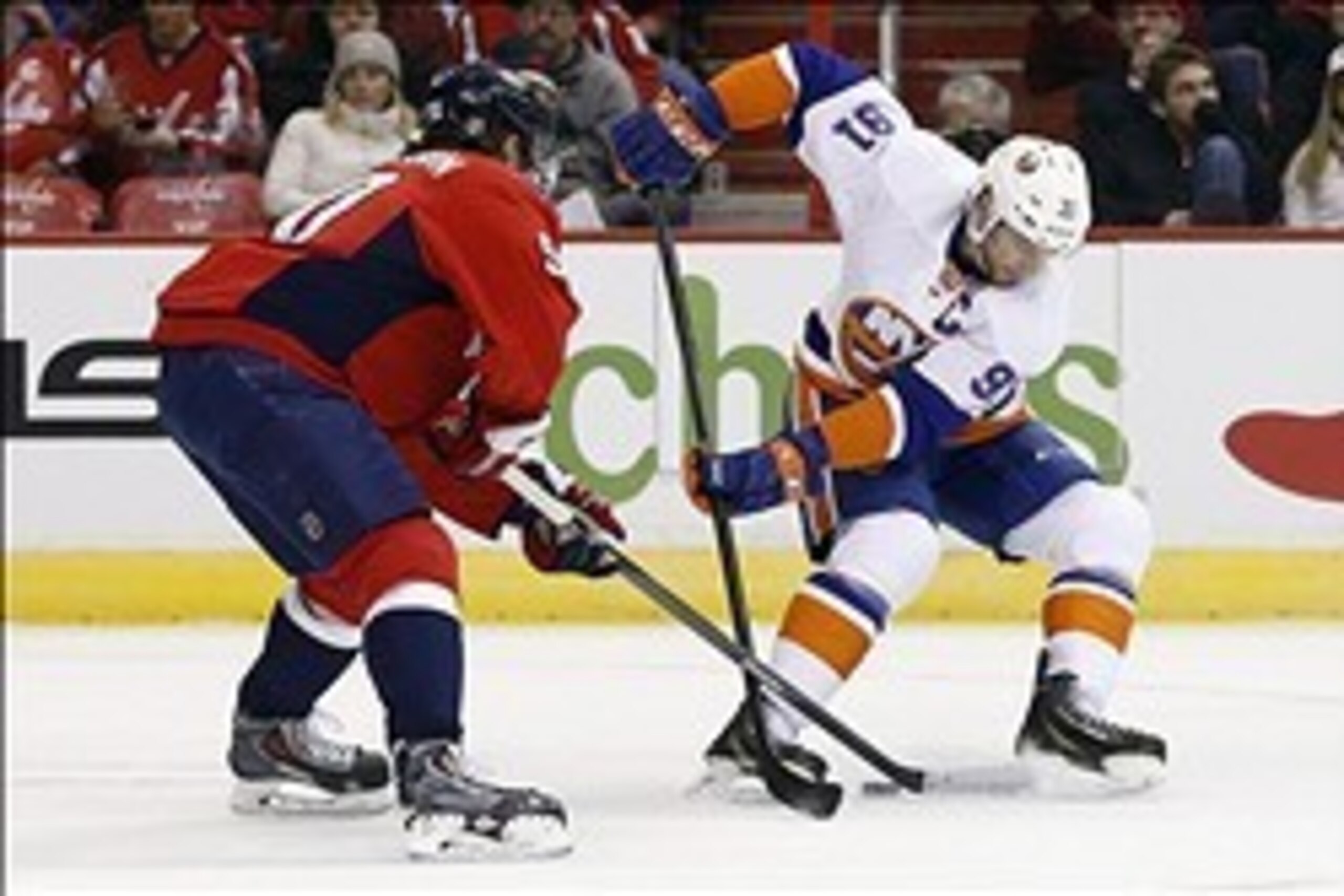 Feb 4, 2014; Washington, DC, USA; Washington Capitals center Marcus Johansson (90) battles for the puck with New York Islanders center John Tavares (91) in the first period at Verizon Center. Mandatory Credit: Geoff Burke-USA TODAY Sports