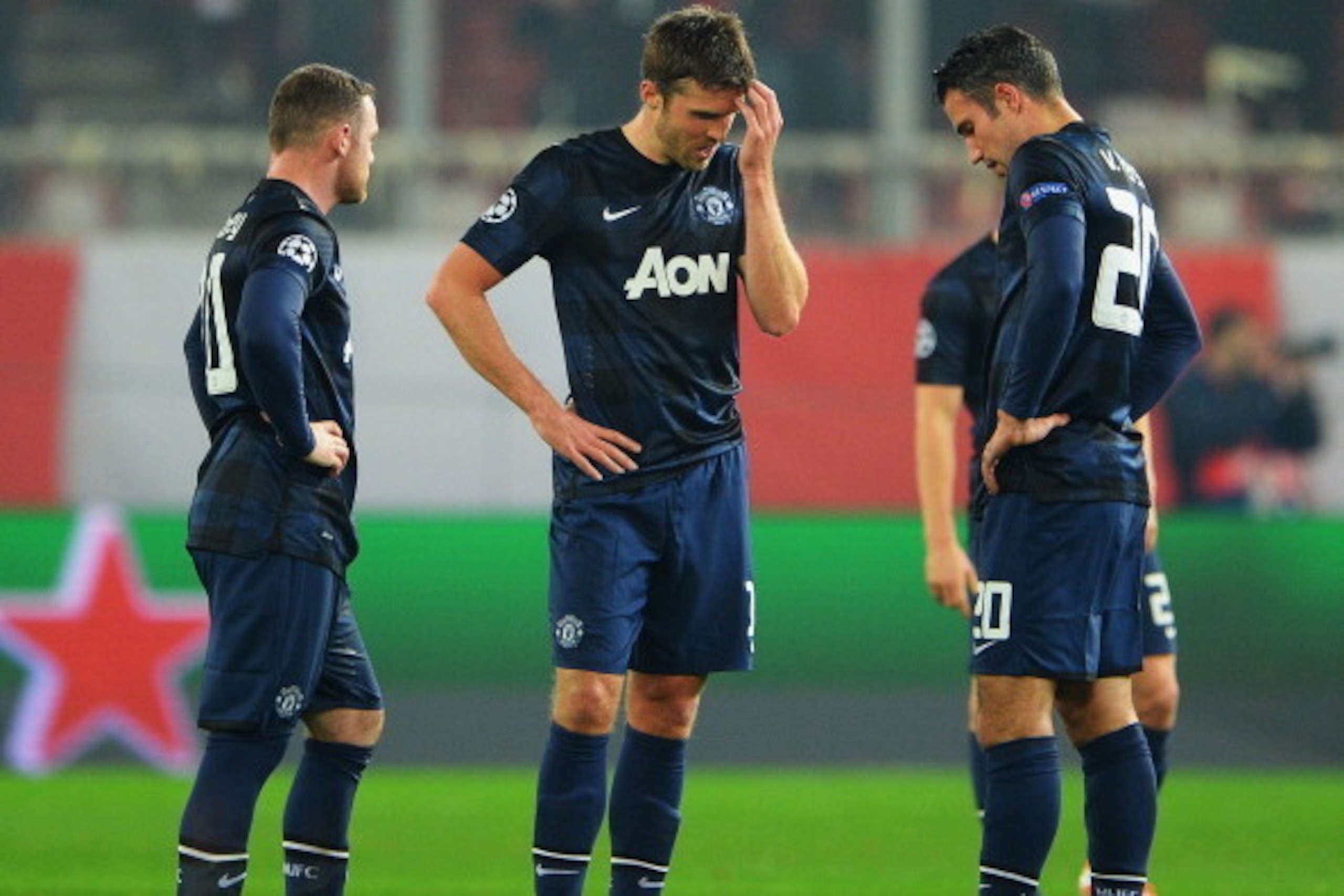 PIRAEUS, GREECE - FEBRUARY 25:  (L-R) Wayne Rooney, Michael Carrick and Robin van Persie  of Manchester United react as they restart the game after conceding the first goal during the UEFA Champions League Round of 16 first leg match between Olympiacos FC