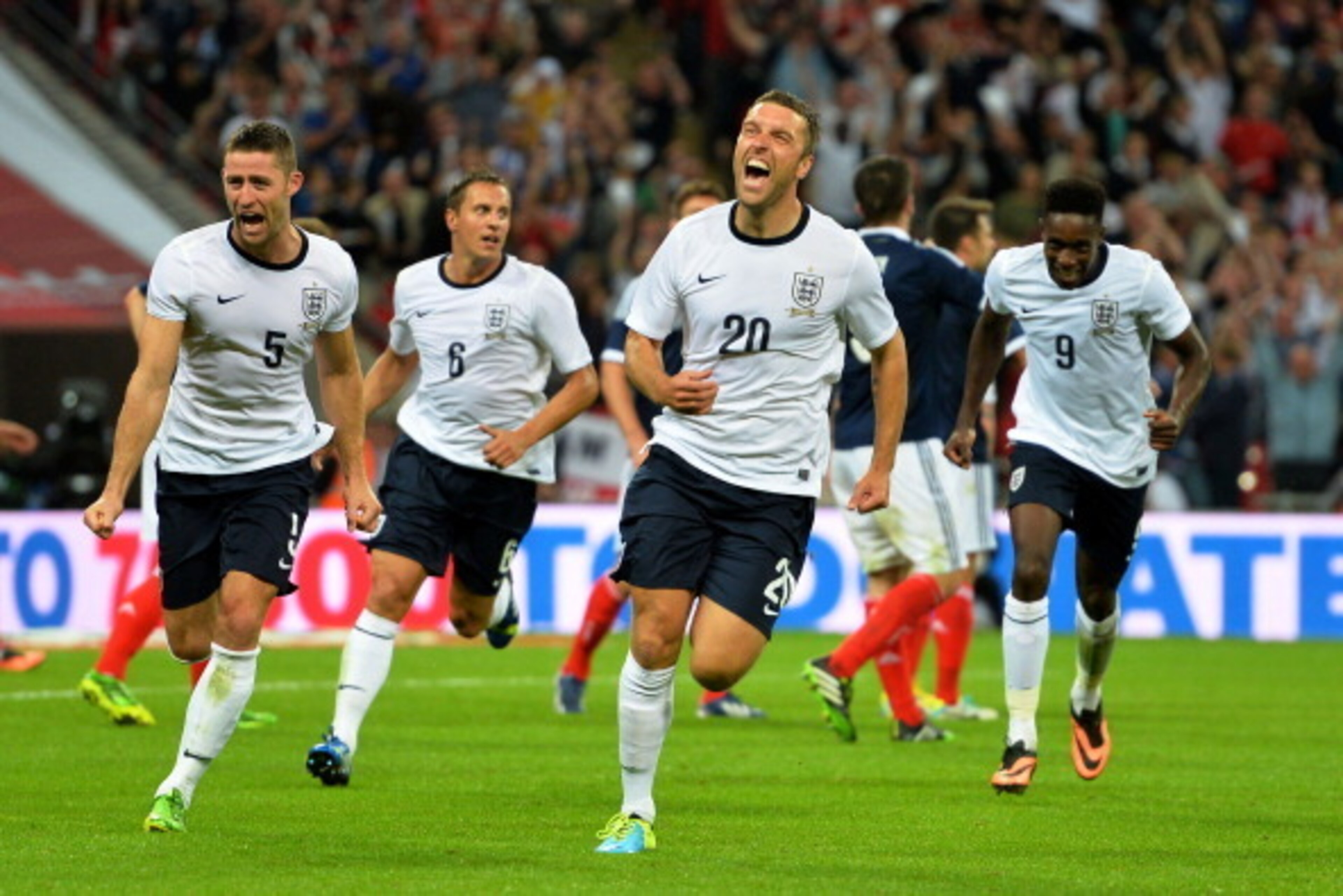 LONDON, ENGLAND - AUGUST 14:  Rickie Lambert of England (C) celebrates with team-mates Gary Cahill of England (L) and Danny Welbeck of England (R) after scoring a goal during the International Friendly match between England and Scotland at Wembley Stadium