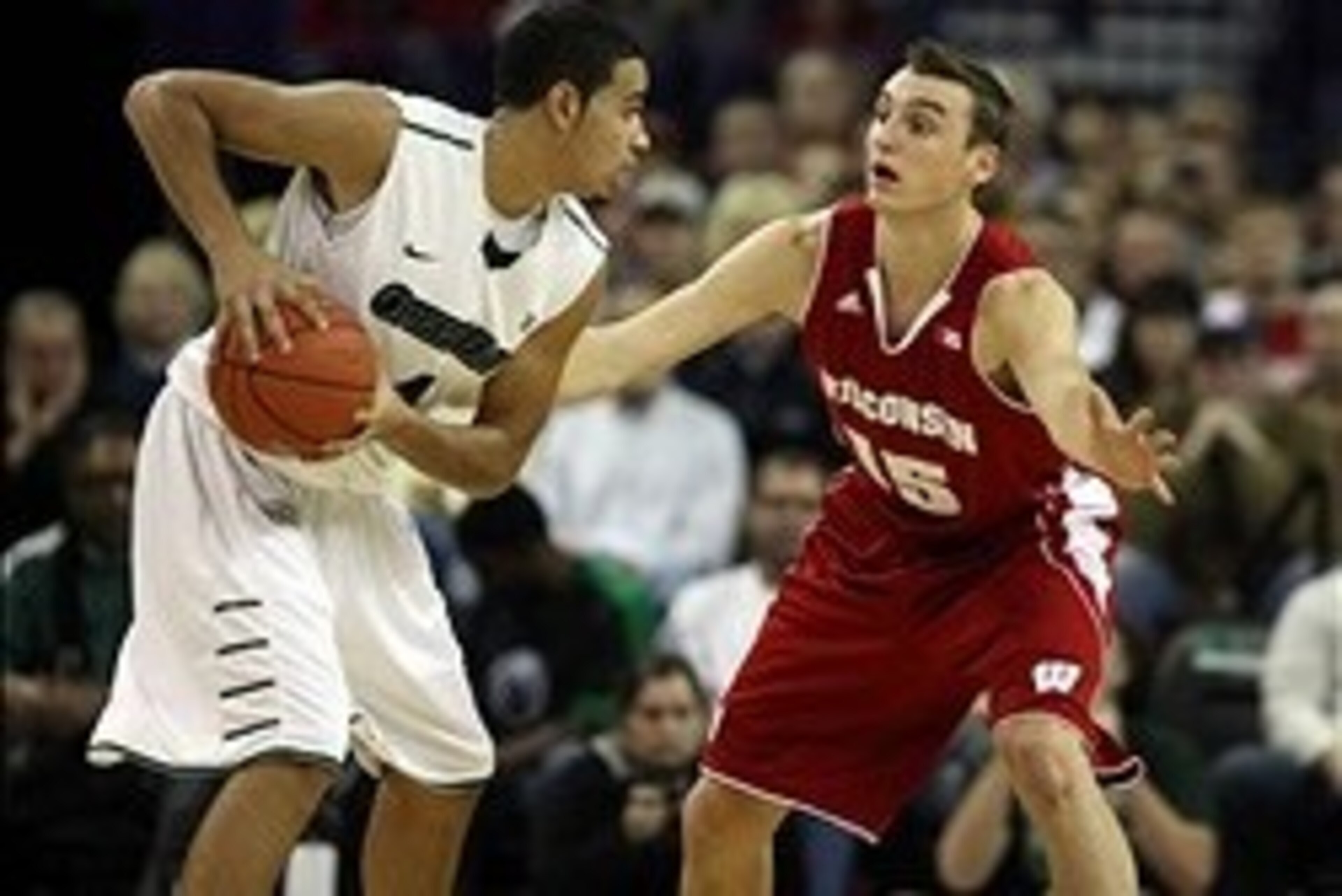 Nov 16, 2013; Green Bay, WI, USA; Wisconsin-Green Bay Phoenix guard Jordan Fouse (4) looks to pass as Wisconsin Badgers forward Sam Dekker (15) defends at the Resch Center in Ashwaubenon. The Wisconsin Badgers defeated Wisconsin-Green Bay 69-66.  Mandator