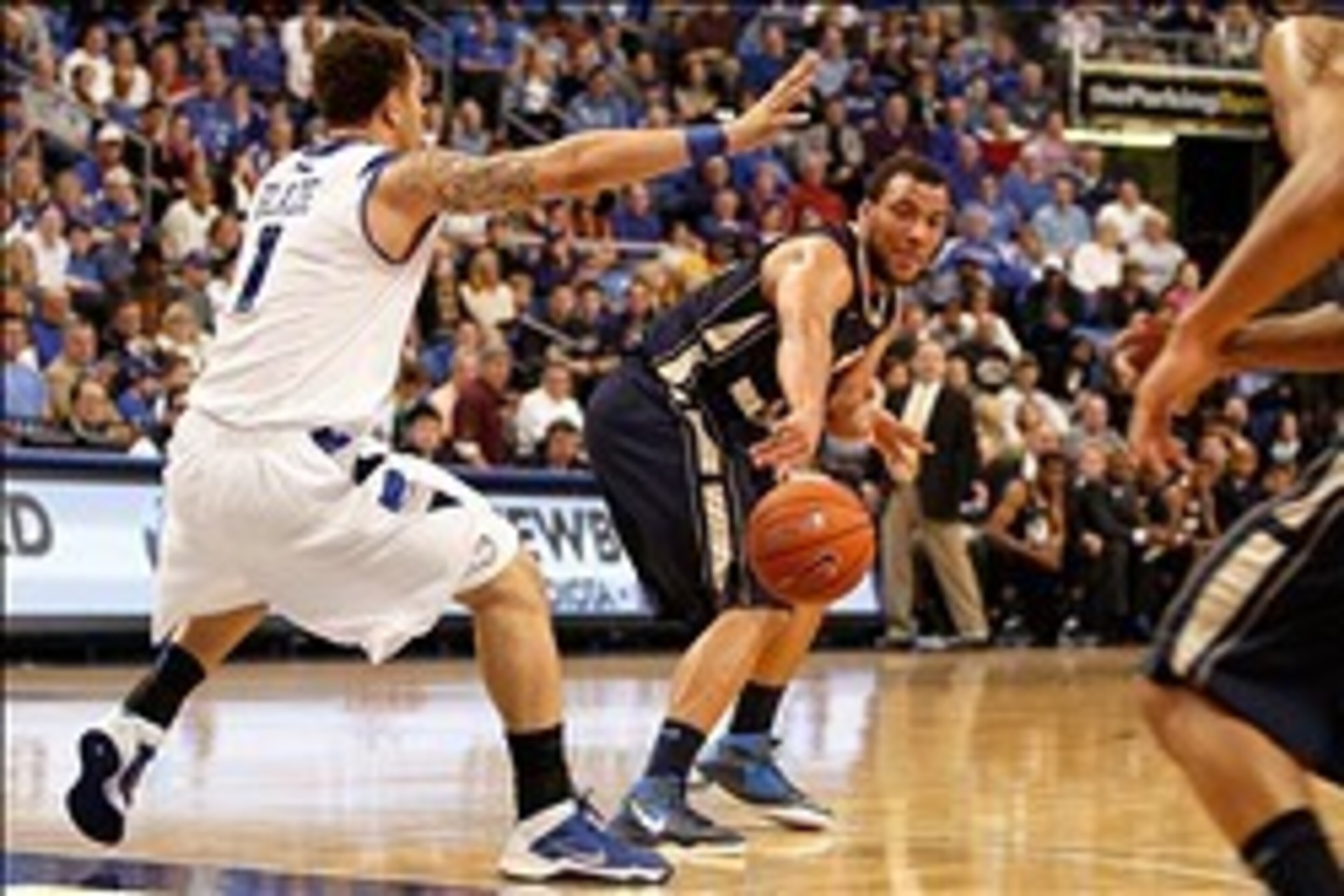 Feb 22, 2014; St. Louis, MO, USA; George Washington Colonials forward Kevin Larsen (21) passes the ball as Saint Louis Billikens forward Grandy Glaze (1) defends during the first half at Chaifetz Arena. Mandatory Credit: Scott Kane-USA TODAY Sports
