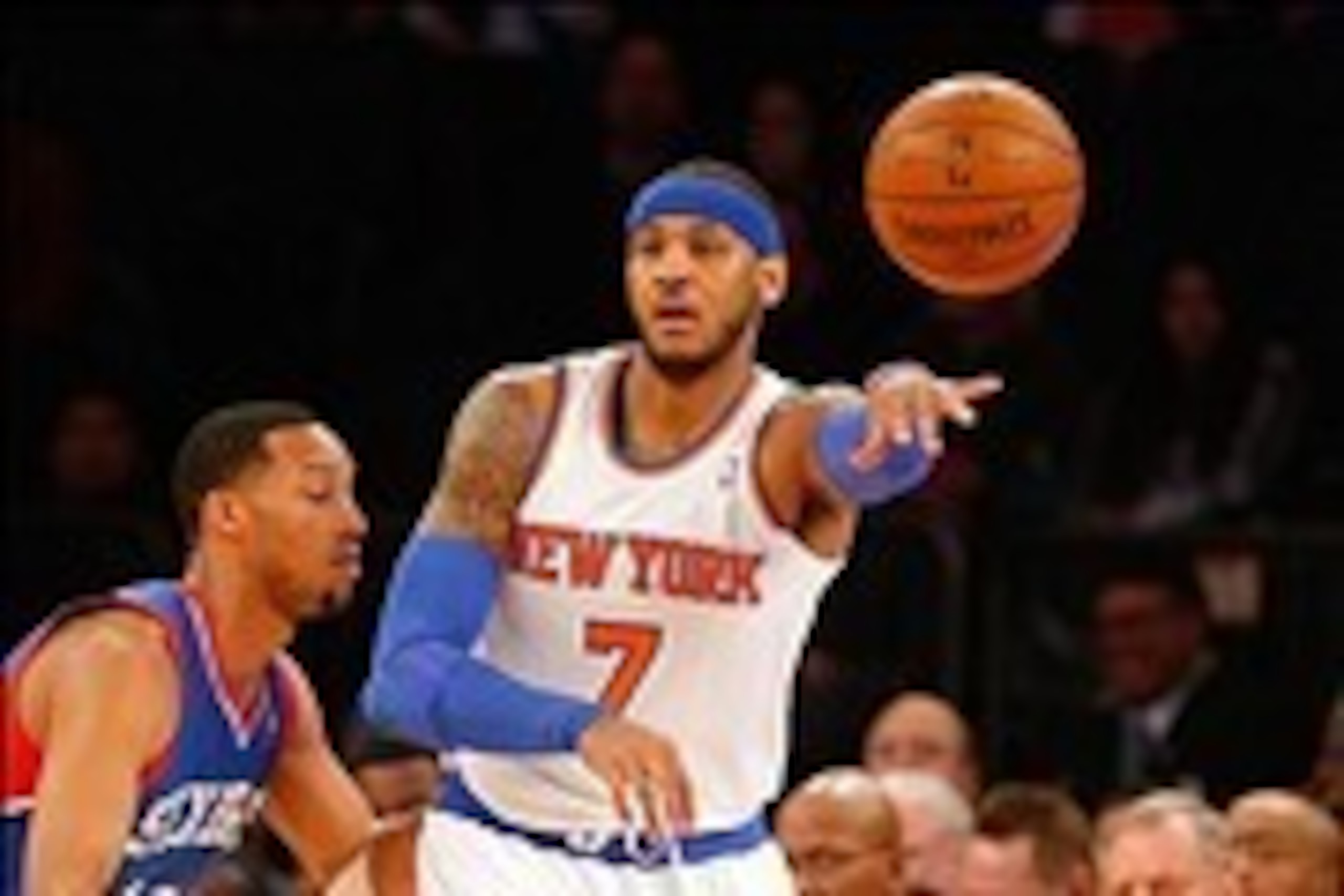 Jan 22, 2014; New York, NY, USA;  New York Knicks small forward Carmelo Anthony (7) passes the ball back outside as he is guarded by Philadelphia 76ers small forward Evan Turner (12) at Madison Square Garden. Mandatory Credit: Jim O'Connor-USA TODAY Sport
