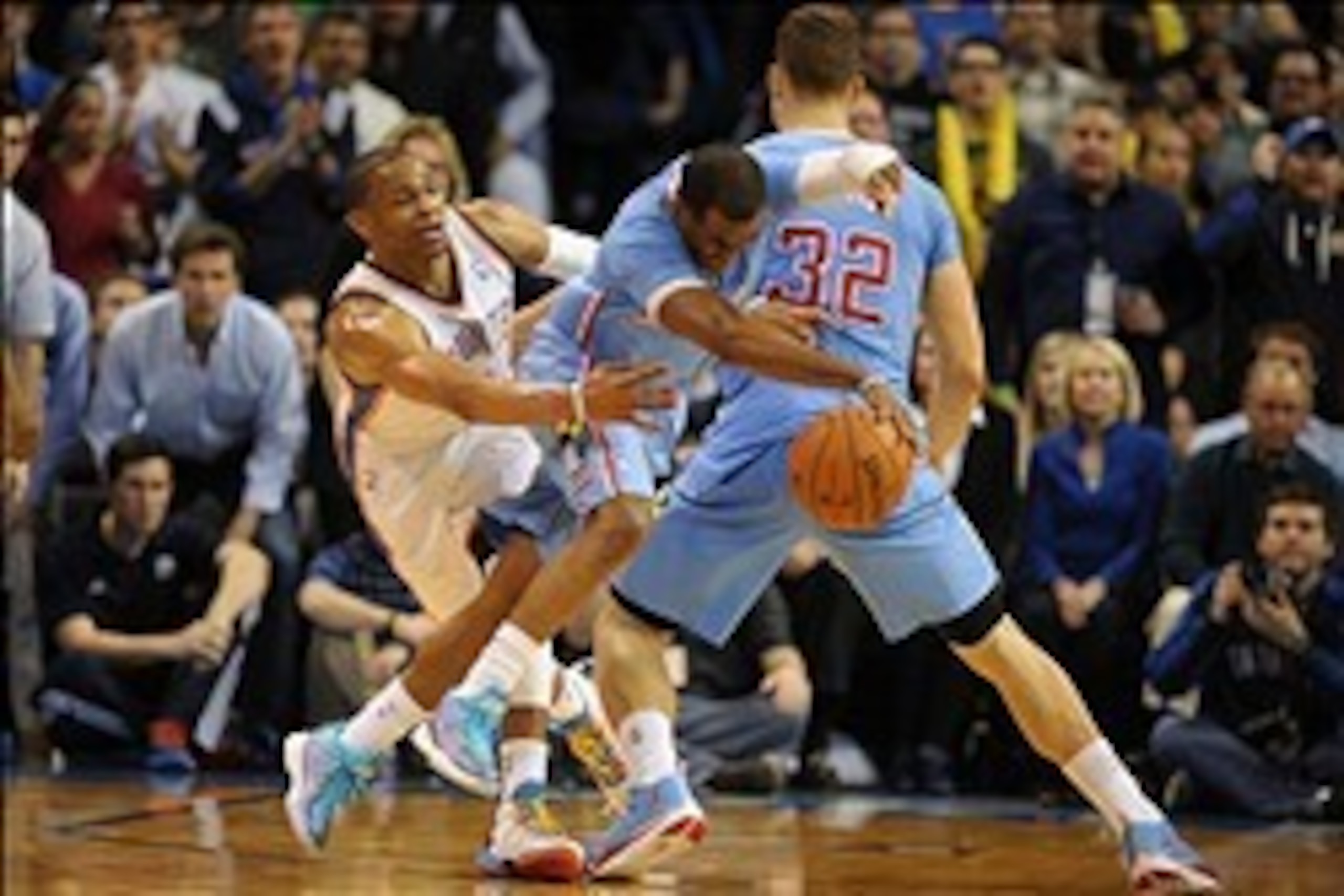 Feb 23, 2014; Oklahoma City, OK, USA; Los Angeles Clippers point guard Chris Paul (3) runs around a pick set by Los Angeles Clippers power forward Blake Griffin (32) while being pursued by Oklahoma City Thunder point guard Russell Westbrook (0) during the