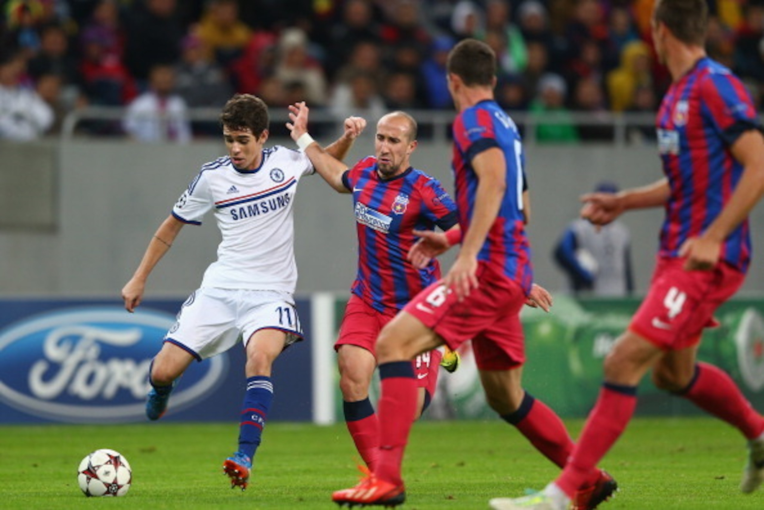 BUCHAREST, ROMANIA - OCTOBER 01: Oscar (L) of Chelsea is tracked by Iasmin Latovlevici (2L) of Steaua Bucurestiduring the UEFA Champions League Group E Match between FC Steaua Bucuresti and Chelsea at the National Arena Stadium on October 1, 2013 in Bucha