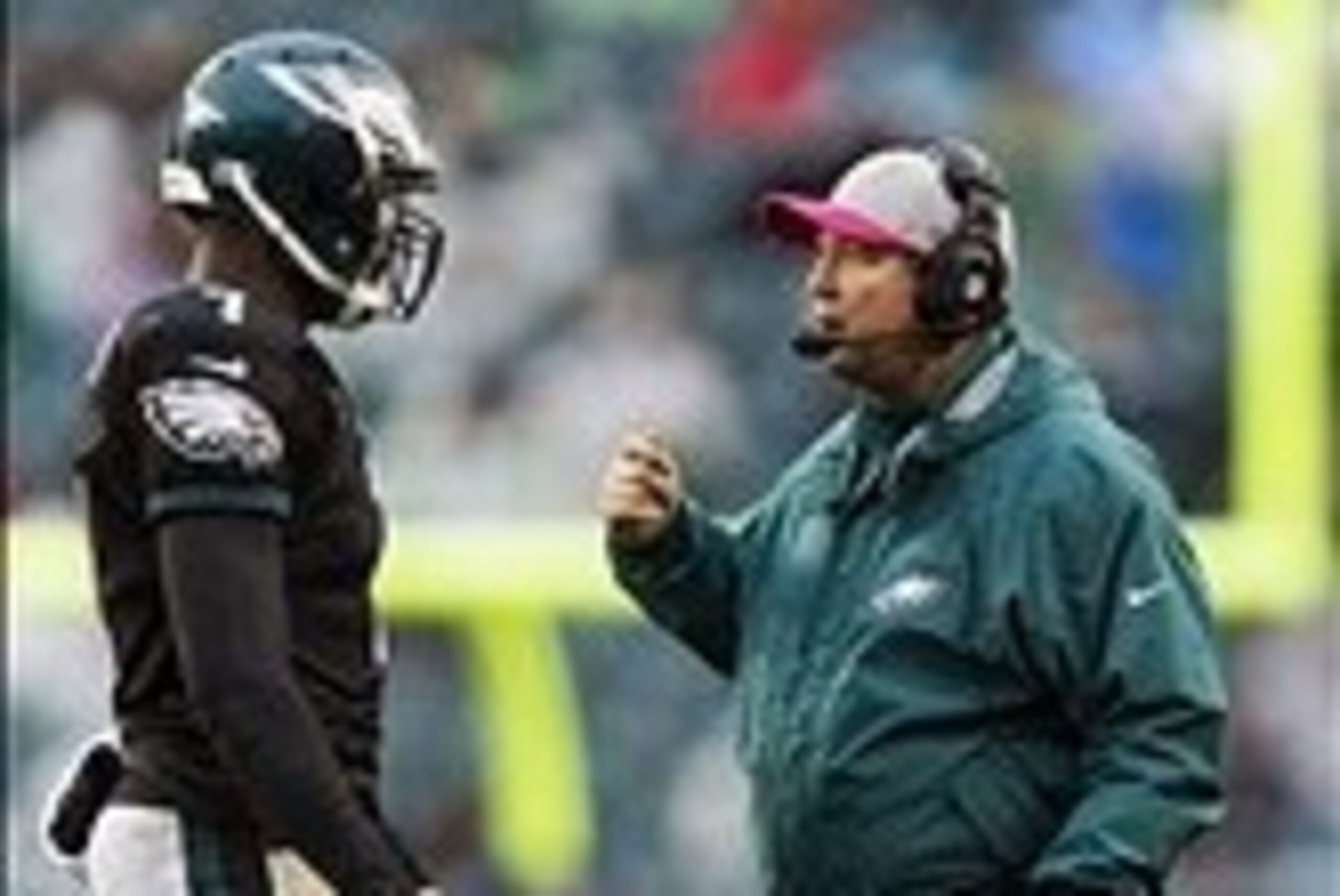 Oct 28, 2012; Philadelphia, PA, USA; Philadelphia Eagles offensive coordinator Marty Mornhinweg talks with quarterback Michael Vick (7) during the fourth quarter against the Atlanta Falcons at Lincoln Financial Field. The Falcons defeated the Eagles 30-17