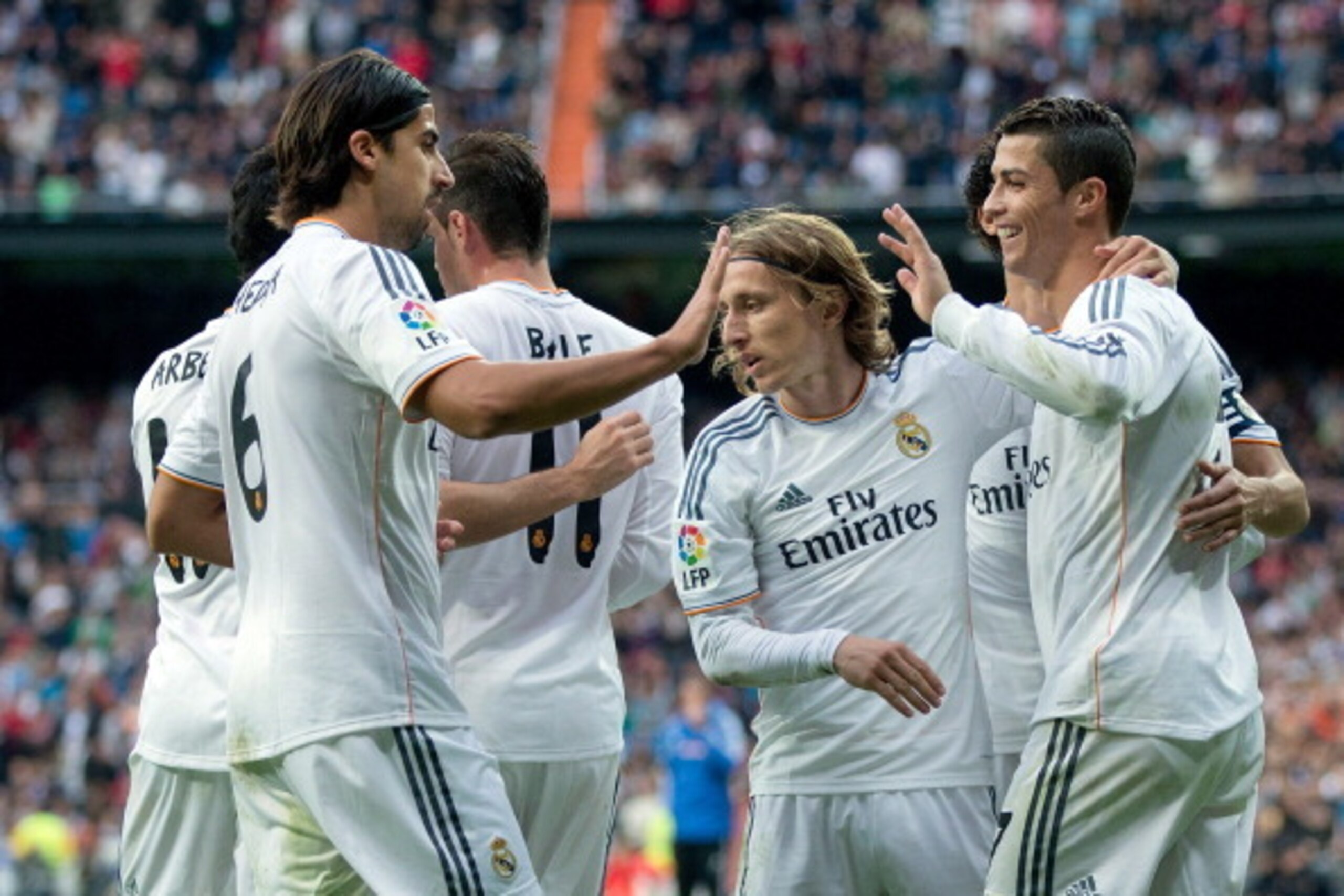 MADRID, SPAIN - NOVEMBER 09:  Cristiano Ronaldo (R) of Real Madrid CF celebrates scoring their fifth goal with teammates Luka Modric (2ndR) and Sami Khedira (L) during the La Liga match between Real Madrid CF and Real Sociedad de Futbol  at Estadio Santia