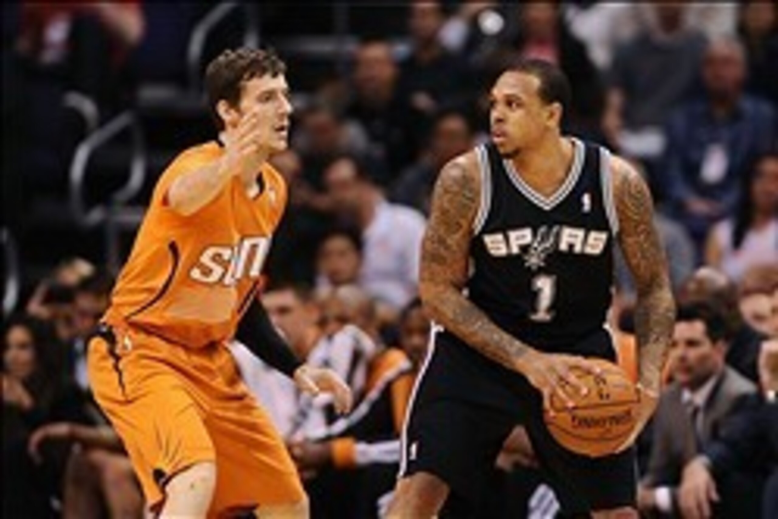 Feb 21, 2014; Phoenix, AZ, USA; San Antonio Spurs guard Shannon Brown (1) is defended by Phoenix Suns guard Goran Dragic (1) in the first half at US Airways Center. Mandatory Credit: Jennifer Stewart-USA TODAY Sports
