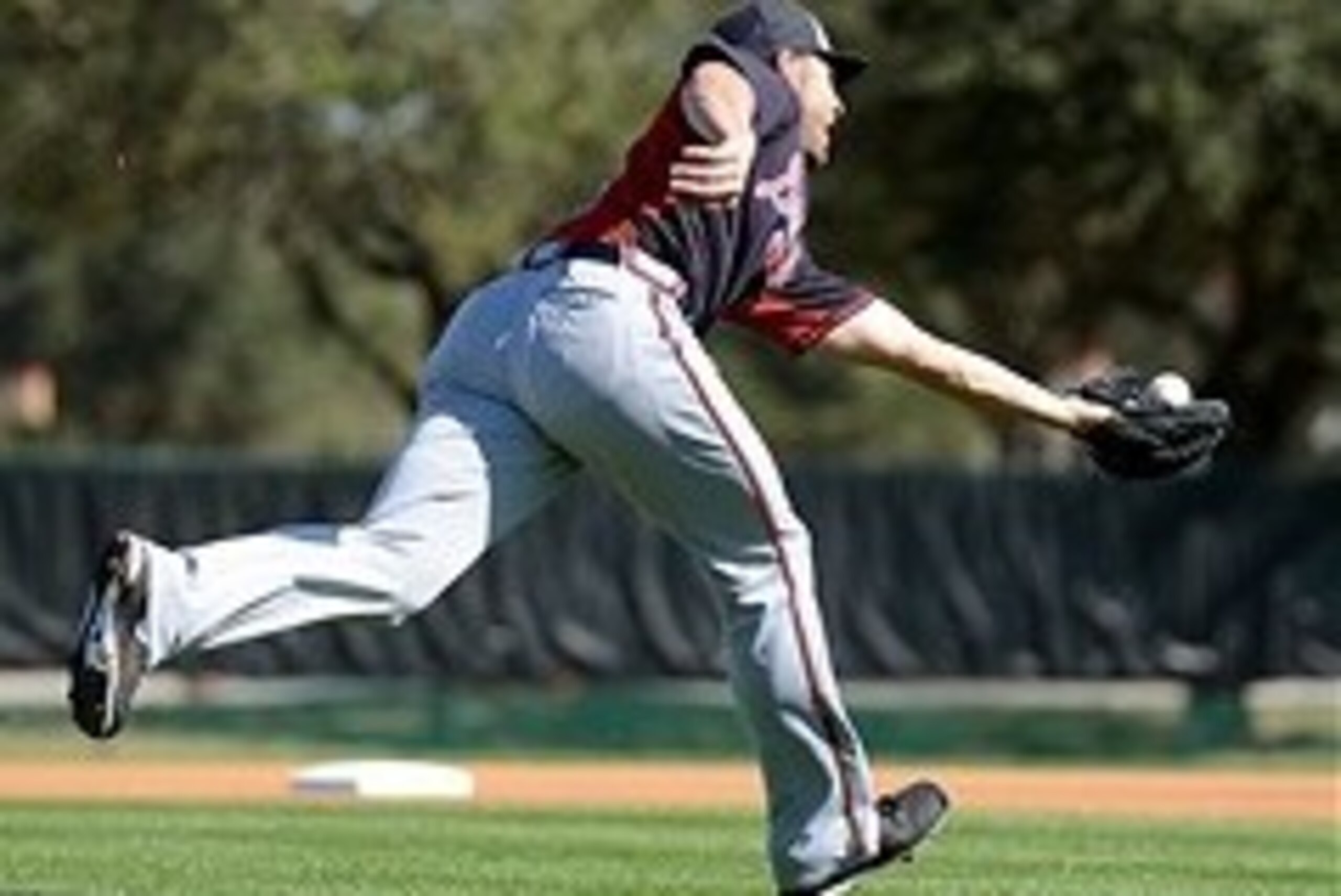 Feb 16, 2014; Lake Buena Vistas, FL, USA; Atlanta Braves pitcher Brandon Beachy (37) catches the ball during spring training at Champion Stadium. Mandatory Credit: Jonathan Dyer-USA TODAY Sports