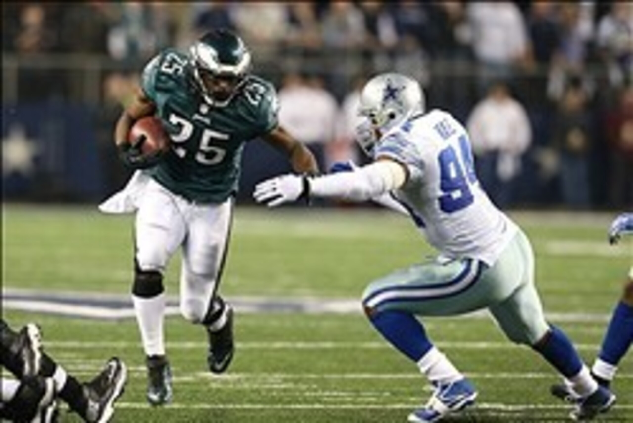 Dec 29, 2013; Arlington, TX, USA; Philadelphia Eagles running back LeSean McCoy (25) runs with the ball against Dallas Cowboys defensive end DeMarcus ware (94) in the fourth quarter at AT&T Stadium. The Eagle beat the Cowboys 24-22. Mandatory Credit: Matt