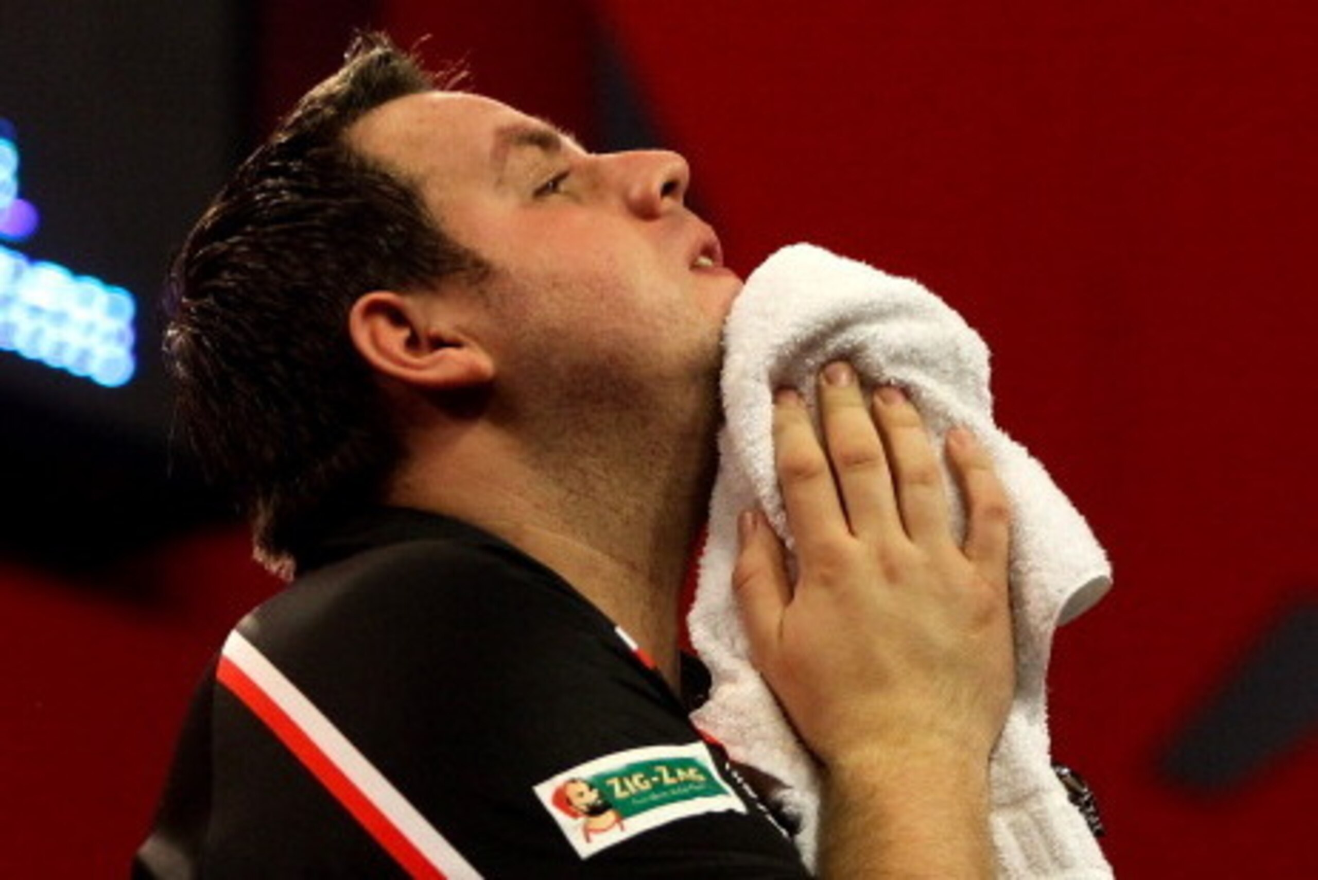 LONDON, ENGLAND - DECEMBER 30:  Adrian Lewis of England reacts after being defeated by Michael van Gerwen of The Netherlands in their semi final match on day fifteen of the Ladbrokes.com World Darts Championship at Alexandra Palace on December 30, 2013 in