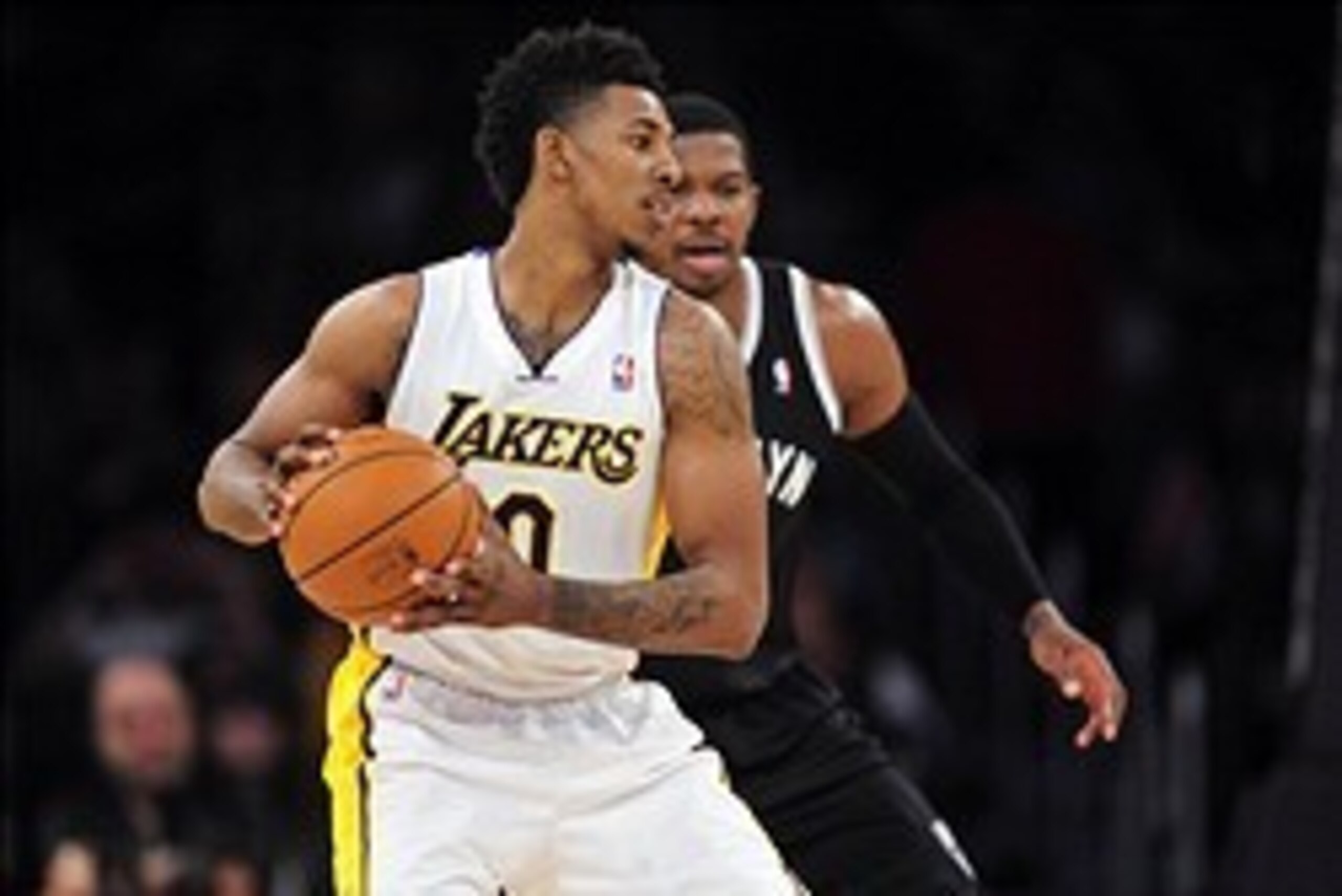February 23, 2014; Los Angeles, CA, USA; Los Angeles Lakers small forward Nick Young (0) controls the ball  against the Brooklyn Nets during the first half at Staples Center. Mandatory Credit: Gary A. Vasquez-USA TODAY Sports