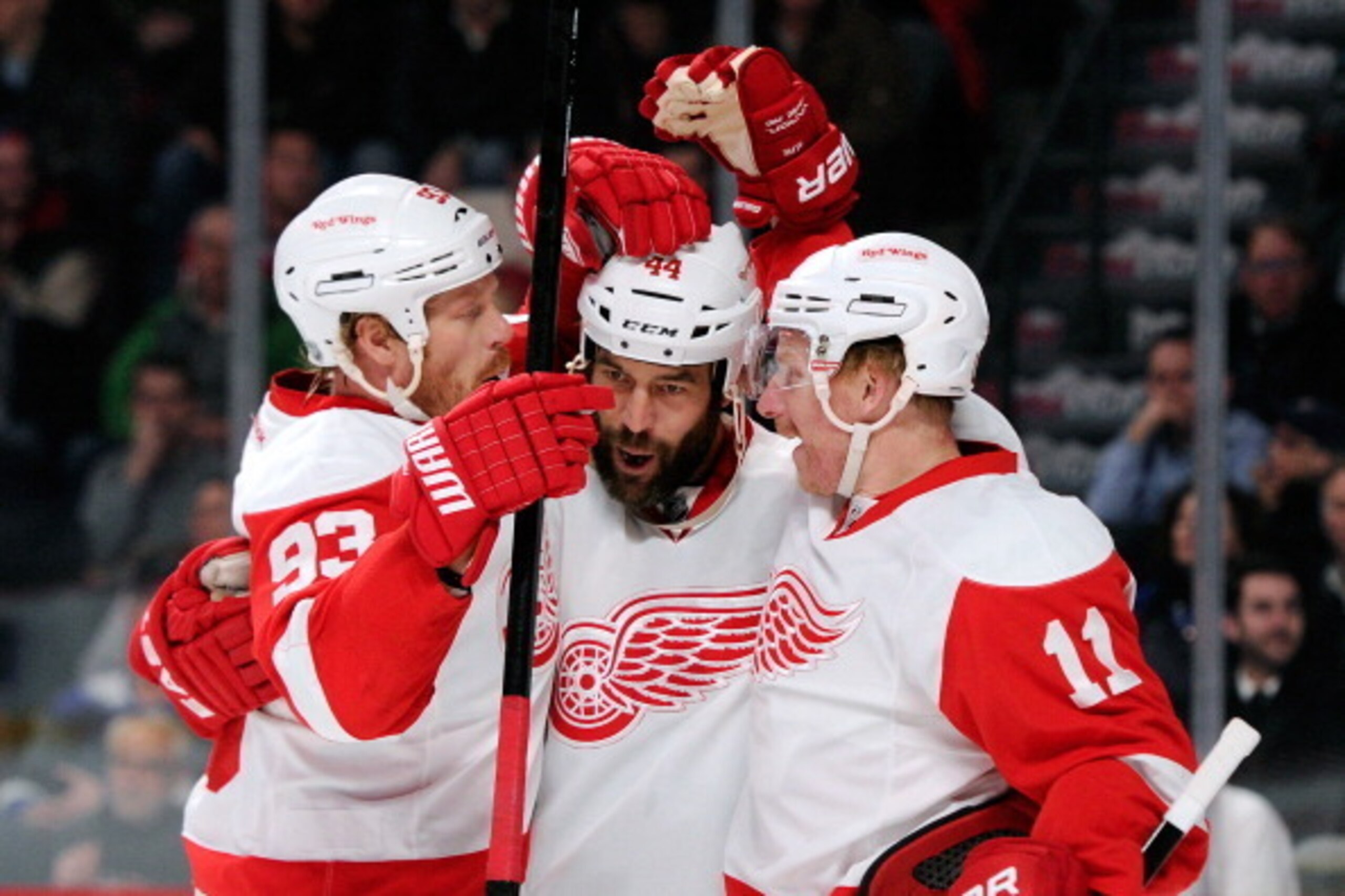 MONTREAL, QC - FEBRUARY 26:  Todd Bertuzzi #44 of the Detroit Red Wings celebrates his first-period goal with teammates Johan Franzen #93 and Daniel Alfredsson #11 during the NHL game against the Montreal Canadiens at the Bell Centre on February 26, 2014 