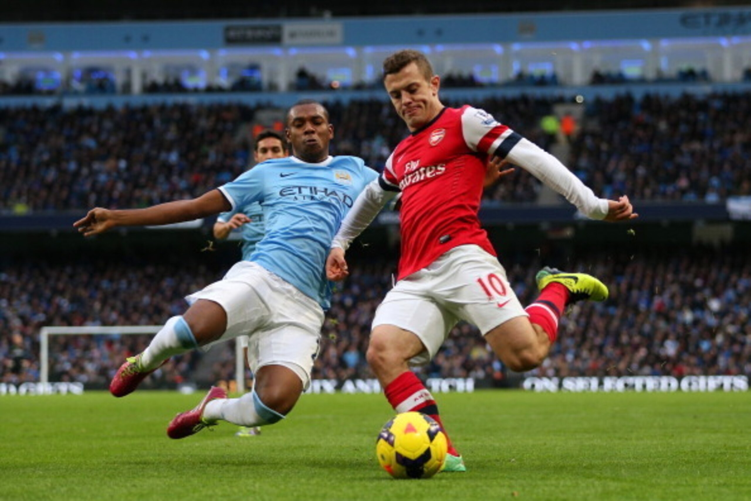 MANCHESTER, ENGLAND - DECEMBER 14: Fernandinho of Manchester City and Jack Wilshere of Arsenal battle for the ball during the Barclays Premier League match between Manchester City and Arsenal at Etihad Stadium on December 14, 2013 in Manchester, England. 