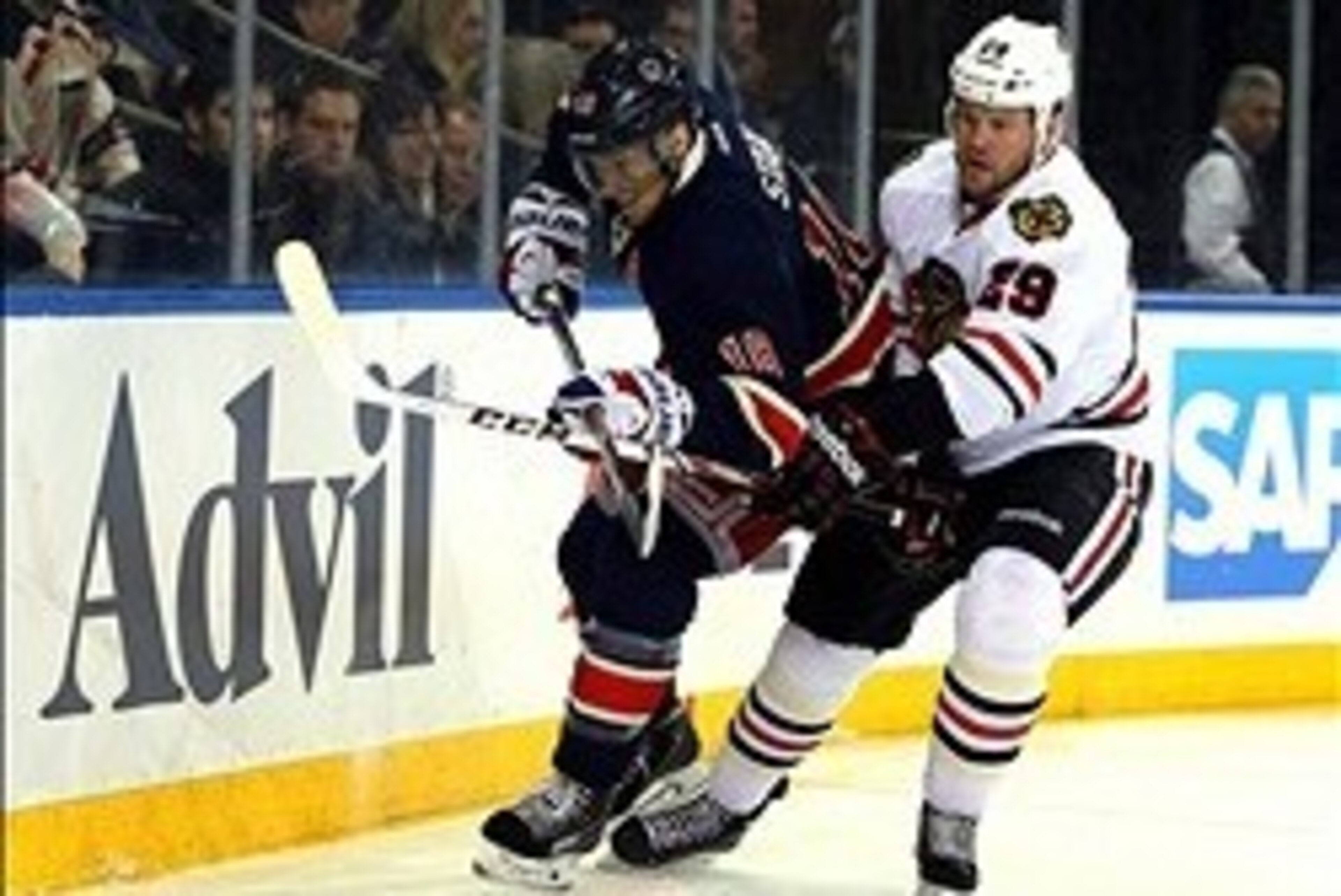 Feb 27, 2014; New York, NY, USA; New York Rangers defenseman Marc Staal (18) and Chicago Blackhawks left wing Bryan Bickell (29) battle for the puck during the first period at Madison Square Garden. Mandatory Credit: Adam Hunger-USA TODAY Sports