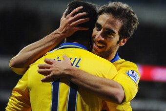 CARDIFF, WALES - NOVEMBER 30:  Mathieu Flamini of Arsenal (R) celebrates with Mesut Oezil as he scores their second goal during the Barclays Premier League match between Cardiff City and Arsenal at Cardiff City Stadium on November 30, 2013 in Cardiff, Wal