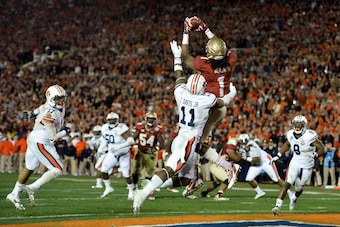 Jan 6, 2014; Pasadena, CA, USA; Florida State Seminoles wide receiver Kelvin Benjamin (1) catches a touchdown pass over Auburn Tigers cornerback Chris Davis (11) during the second half of the 2014 BCS National Championship game at the Rose Bowl.  Mandator