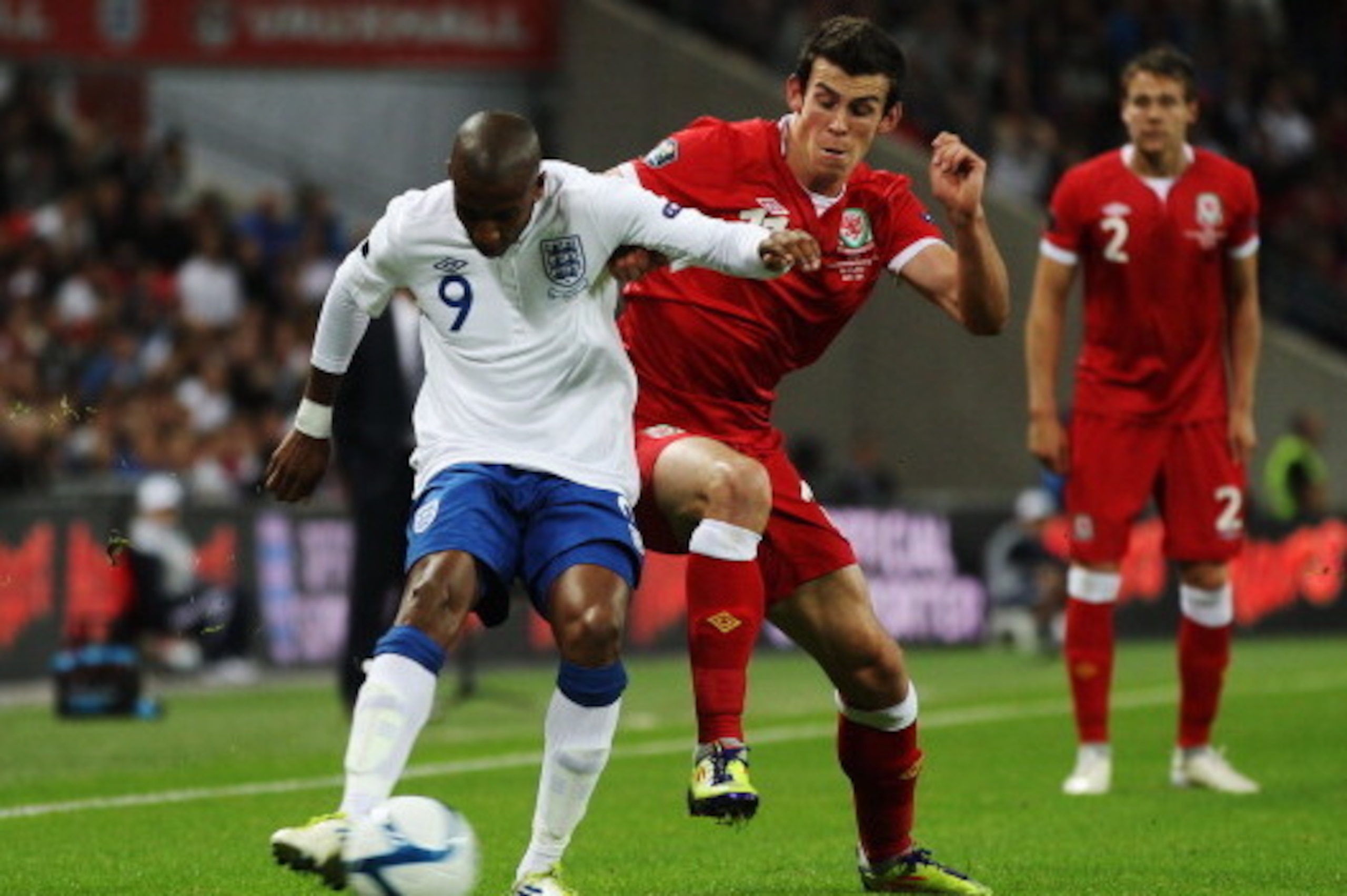 LONDON, ENGLAND - SEPTEMBER 06:  Ashley Young (L) of England holds off the challenge of Gareth Bale (R) of Wales during the UEFA EURO 2012 group G qualifying match between England and Wales at Wembley Stadium  on September 6, 2011 in London, England.  (Ph