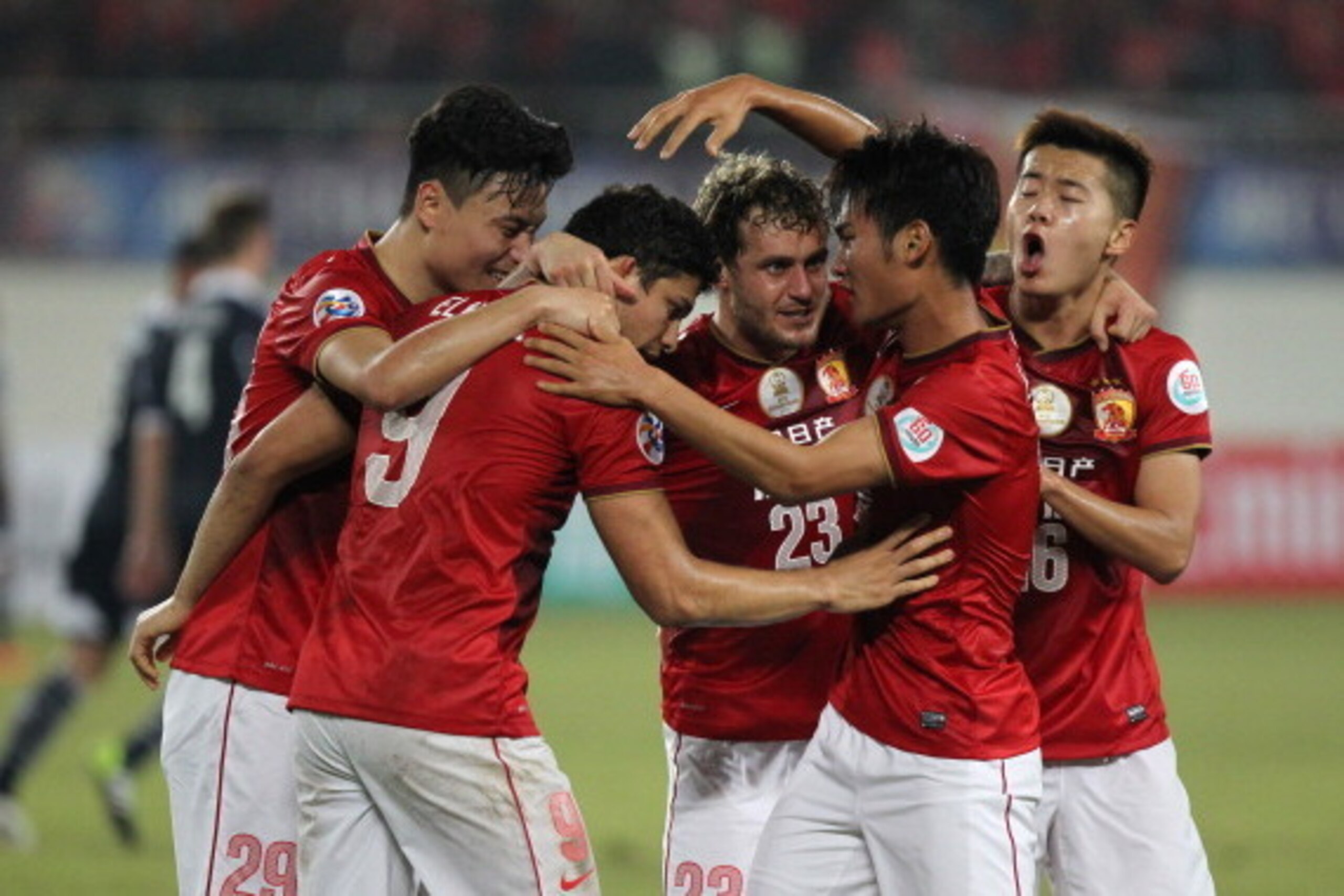 GUANGZHOU, CHINA - FEBRUARY 26:  Elkeson of Guangzhou Evergrande celebrates with Alessandro Diamanti of Guangzhou Evergrande and other teammates after scoring the third team goal during the Asian Champions League match between Guangzhou Evergrande and Mel