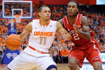 SYRACUSE, NY - FEBRUARY 15:  Tyler Ennis #11 of the Syracuse Orange drives to the basket against the defense of Anthony Barber #2 of the North Carolina State Wolfpack during the first half at the Carrier Dome on February 15, 2014 in Syracuse, New York.  (