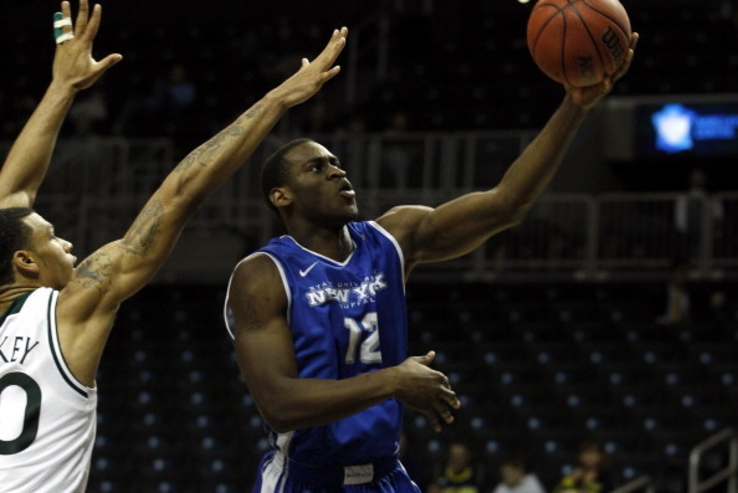 NEW YORK, NY - DECEMBER 21:  Javon McCrea #12 of the Buffalo Bulls drives to the basket past Ashton Pankey #30 of the Manhattan Jaspers during the Brooklyn Hoops Holiday Invitational at Barclays Center on December 21, 2013 in the Brooklyn borough of New Y