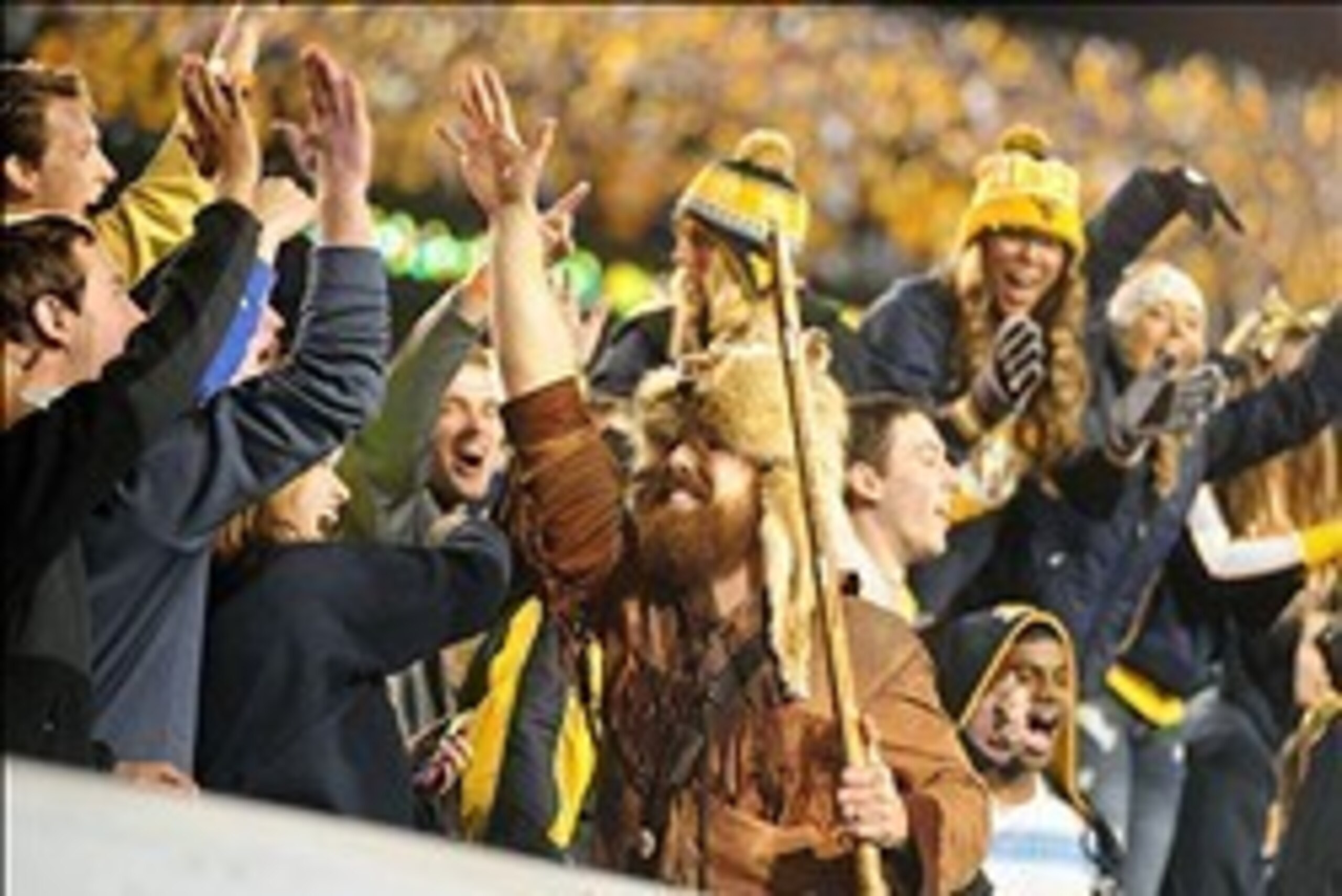 Nov 9, 2013; Morgantown, WV, USA; The West Virginia Mountaineers mascot high fives fans during the game against the Texas Longhorns at Milan Puskar Stadium. Mandatory Credit: Evan Habeeb-USA TODAY Sports