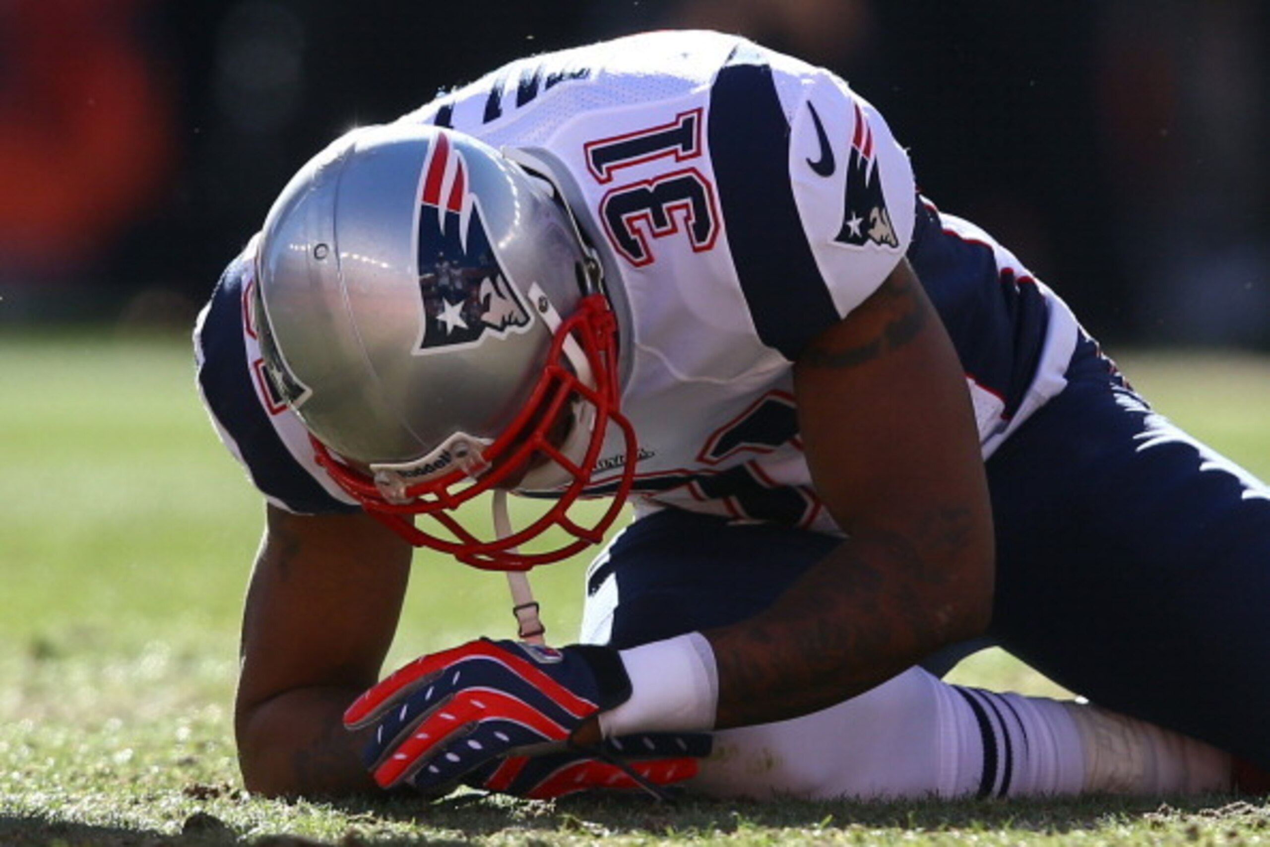 DENVER, CO - JANUARY 19:  Aqib Talib #31 of the New England Patriots kneels over on the ground after colliding with Wes Welker #83 of the Denver Broncos during the AFC Championship game at Sports Authority Field at Mile High on January 19, 2014 in Denver,
