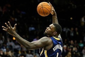 Feb 4, 2014; Atlanta, GA, USA; Indiana Pacers shooting guard Lance Stephenson (1) attempts a dunk over Atlanta Hawks power forward Paul Millsap (4) in the second half at Philips Arena. The Pacers won 89-85. Mandatory Credit: Daniel Shirey-USA TODAY Sports