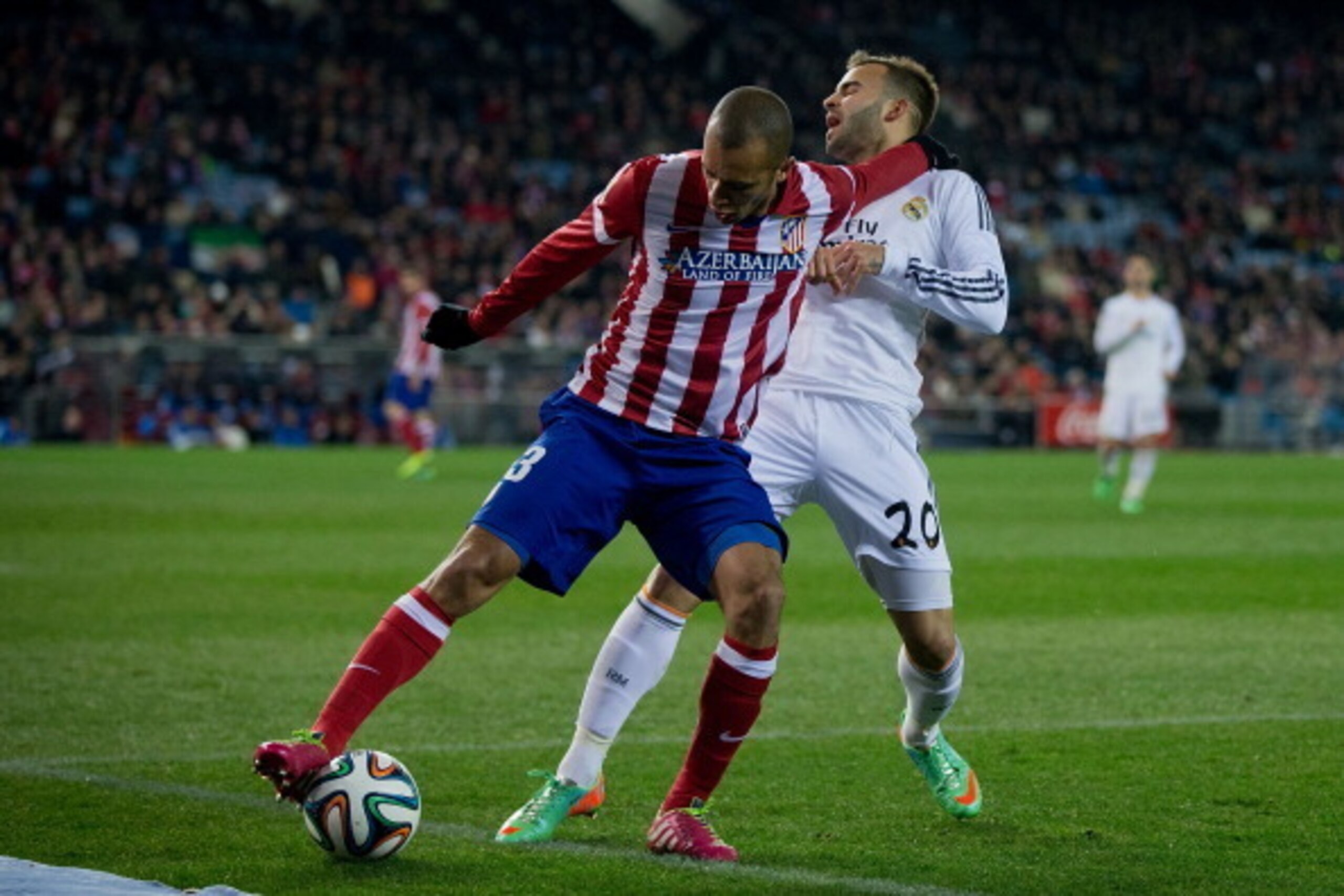 MADRID, SPAIN - FEBRUARY 11: Joao Miranda (L) of Atletico de Madrid holds Jese Rodriguez (R) of Real Madrid CF during the Copa del Rey semi-final second leg match between Club Atletico de Madrid and Real Madrid CF at Vicente Calderon Stadium on February 1