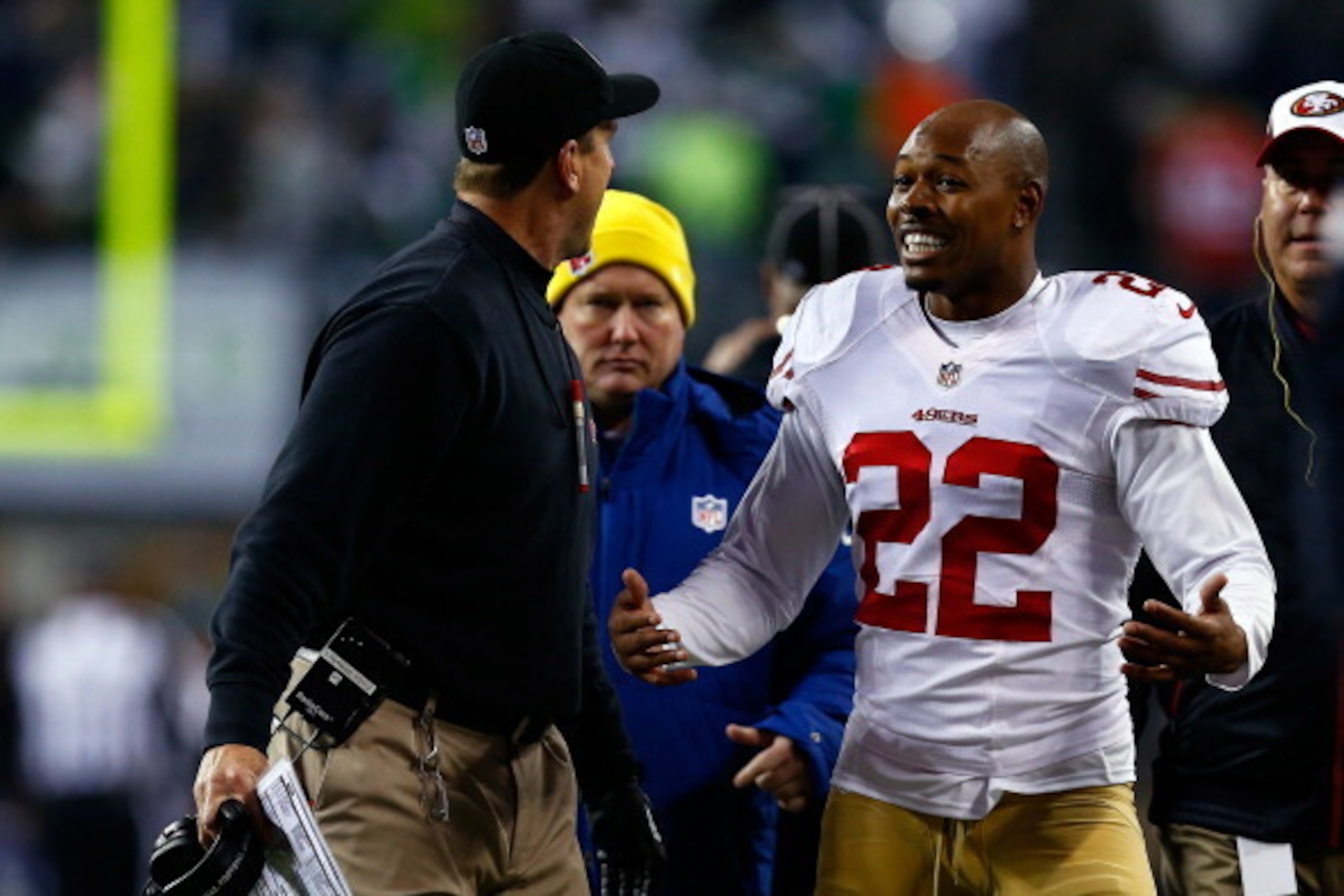 SEATTLE, WA - JANUARY 19:  Cornerback Carlos Rogers #22 of the San Francisco 49ers talks with head coach head coach Jim Harbaugh during the 2014 NFC Championship at CenturyLink Field on January 19, 2014 in Seattle, Washington.  (Photo by Tom Pennington/Ge