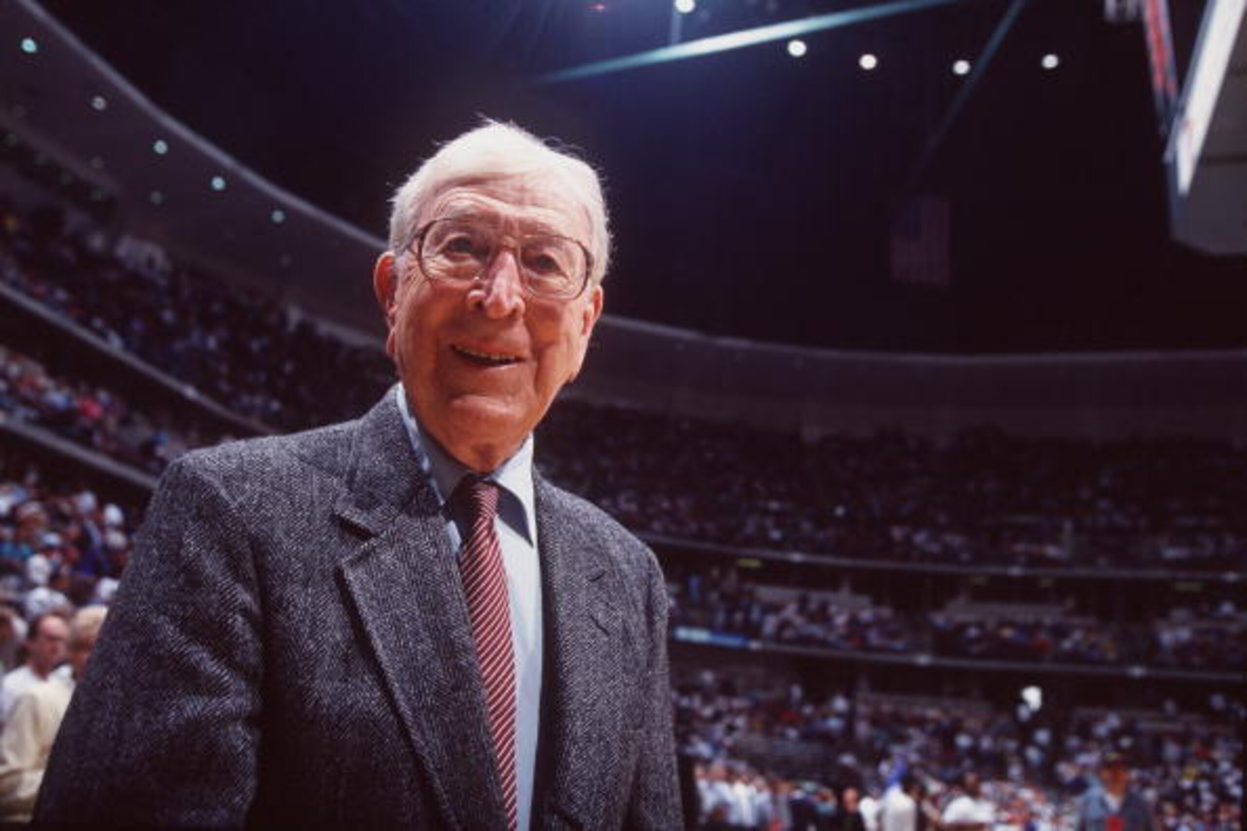 3 DEC 1994:  EX-UCLA HEAD COACH JOHN WOODEN WATCHES THE ACTION DURING THE INAGURAL WOODEN CLASSIC TOURNAMENT AT THE POND IN ANAHEIM, CALIFORNIA. Mandatory Credit: Al Bello/ALLSPORT