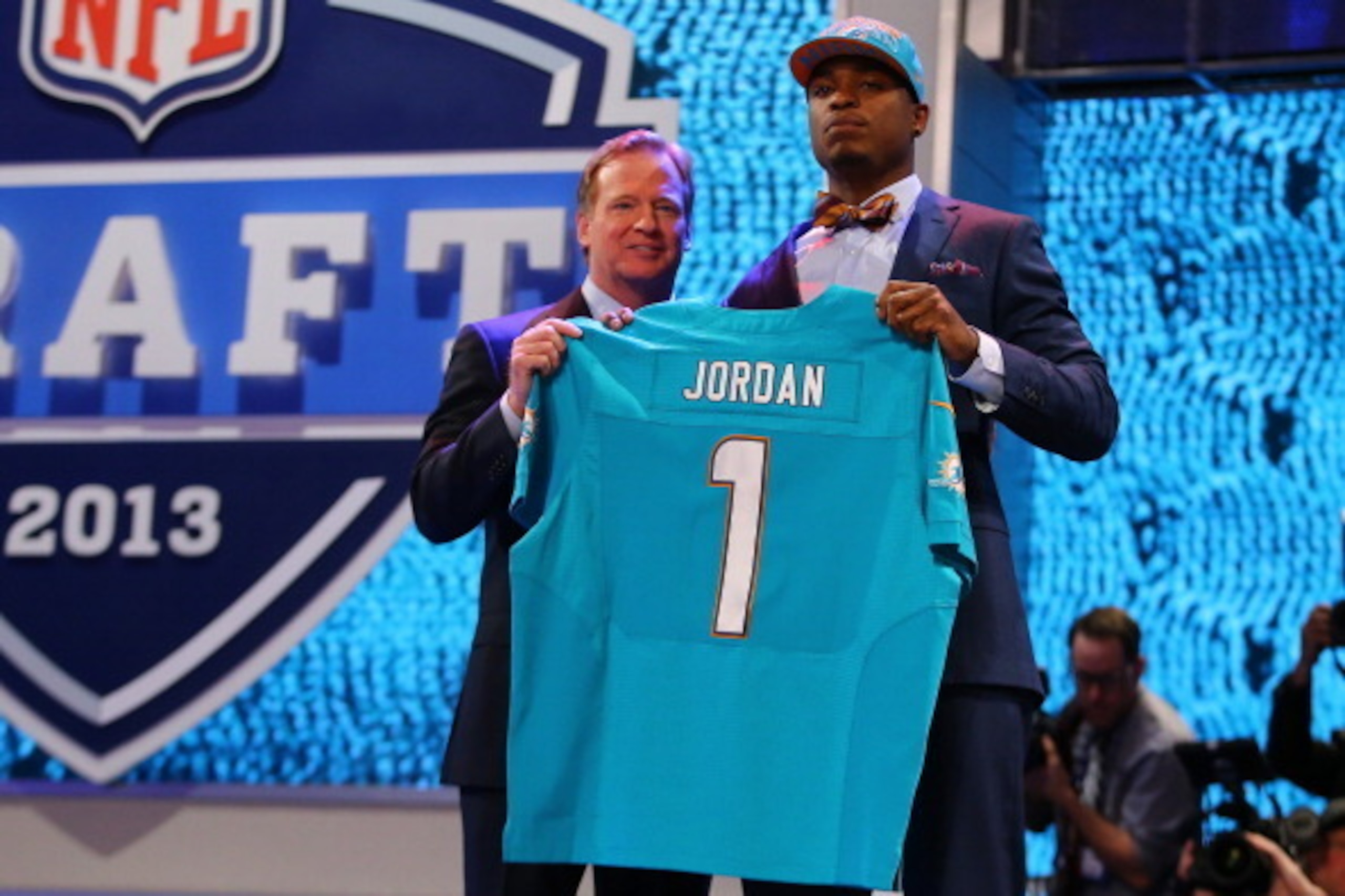 NEW YORK, NY - APRIL 25: Dion Jordan (R) of the Oregon Ducks stands with NFL Commissioner Roger Goodell as they hold up a jersey on stage after he was picked #3 overall by the Miami Dolphins in the first round of the 2013 NFL Draft at Radio City Music Ha NEW YORK, NY - APRIL 25: Dion Jordan (R) of the Oregon Ducks stands with NFL Commissioner Roger Goodell as they hold up a jersey on stage after he was picked #3 overall by the Miami Dolphins in the first round of the 2013 NFL Draft at Radio City Music Ha