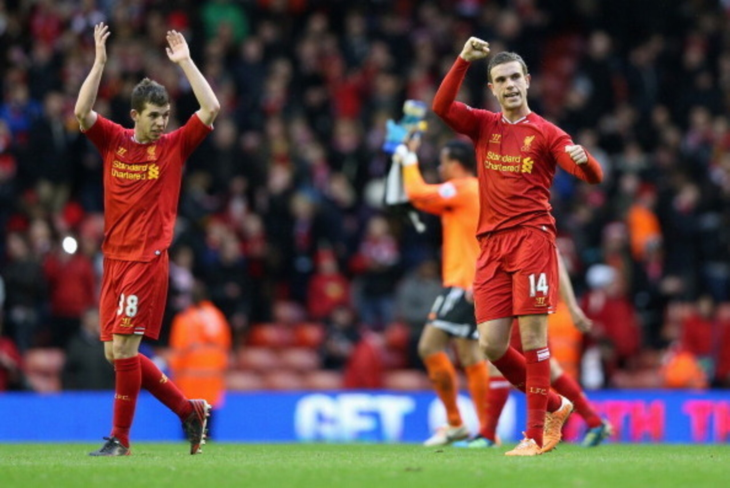 LIVERPOOL, ENGLAND - FEBRUARY 23:  Jordan Henderson of Liverpool celebrates with Jon Flanagan at the end of the Barclays Premier League match between Liverpool and Swansea City at Anfield on February 23, 2014 in Liverpool, England.  (Photo by Clive Brunsk
