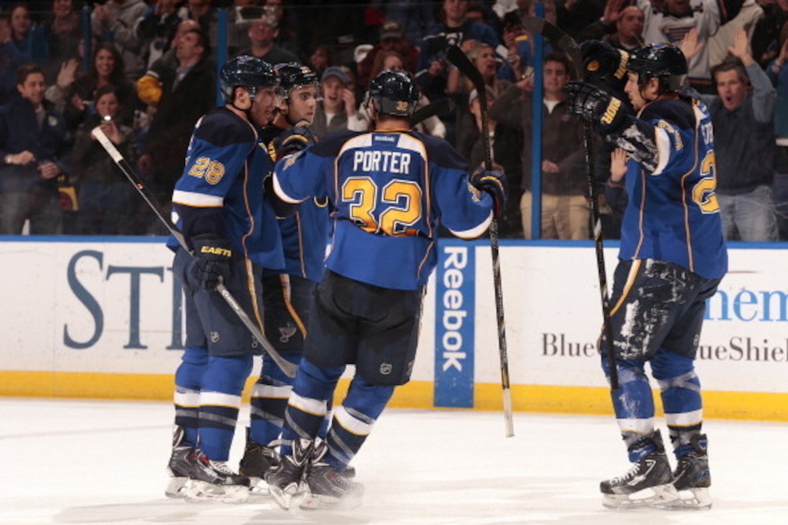 ST. LOUIS, MO - DECEMBER 17: Kevin Shattenkirk #22 of the St. Louis Blues celebrates his goal with teammates Ian Cole #28 Chris Porter #32 and Chris Stewart #25 during an NHL game against the San Jose Sharks on December 17, 2013 at Scottrade Center in St.