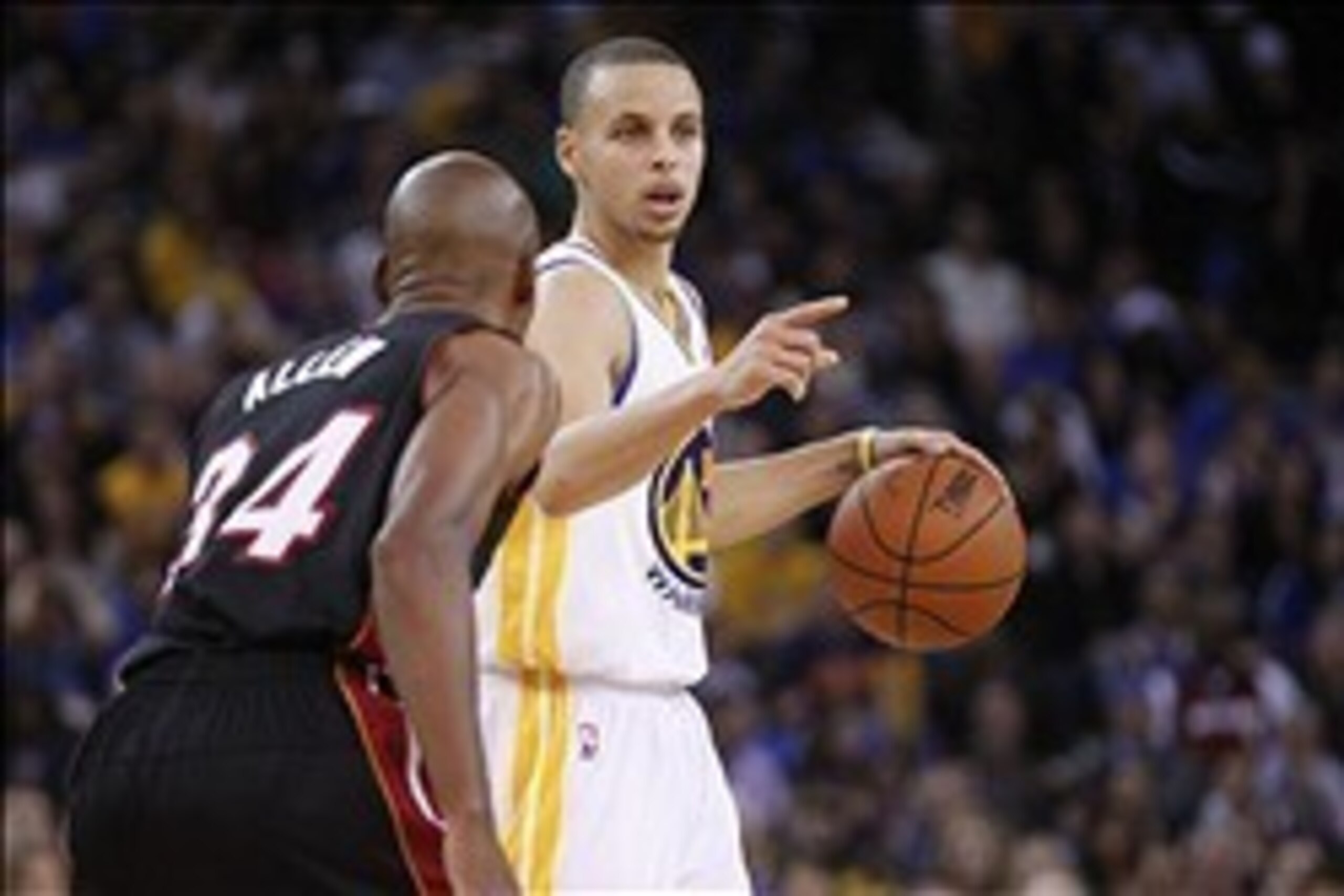Feb 12, 2014; Oakland, CA, USA; Golden State Warriors guard Stephen Curry (30) is defended by Miami Heat guard Ray Allen (34) in the fourth quarter at Oracle Arena. The Heat defeated the Warriors 111-110. Mandatory Credit: Cary Edmondson-USA TODAY Sports
