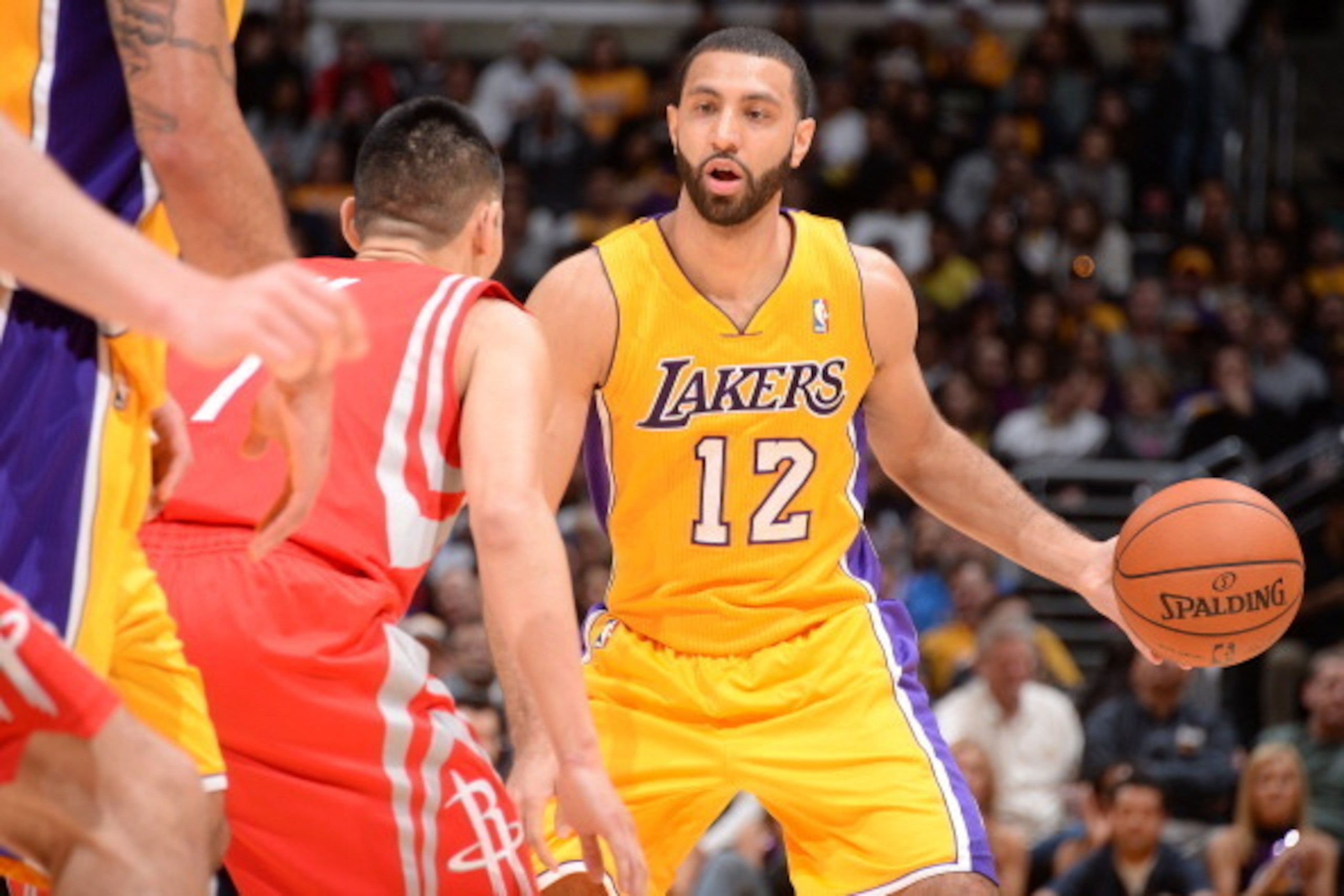 LOS ANGELES, CA - FEBRUARY 19: Kendall Marshall #12 of the Los Angeles Lakers handles the basketball against the Houston Rockets at STAPLES Center on February 19, 2014 in Los Angeles, California. NOTE TO USER: User expressly acknowledges and agrees that, 
