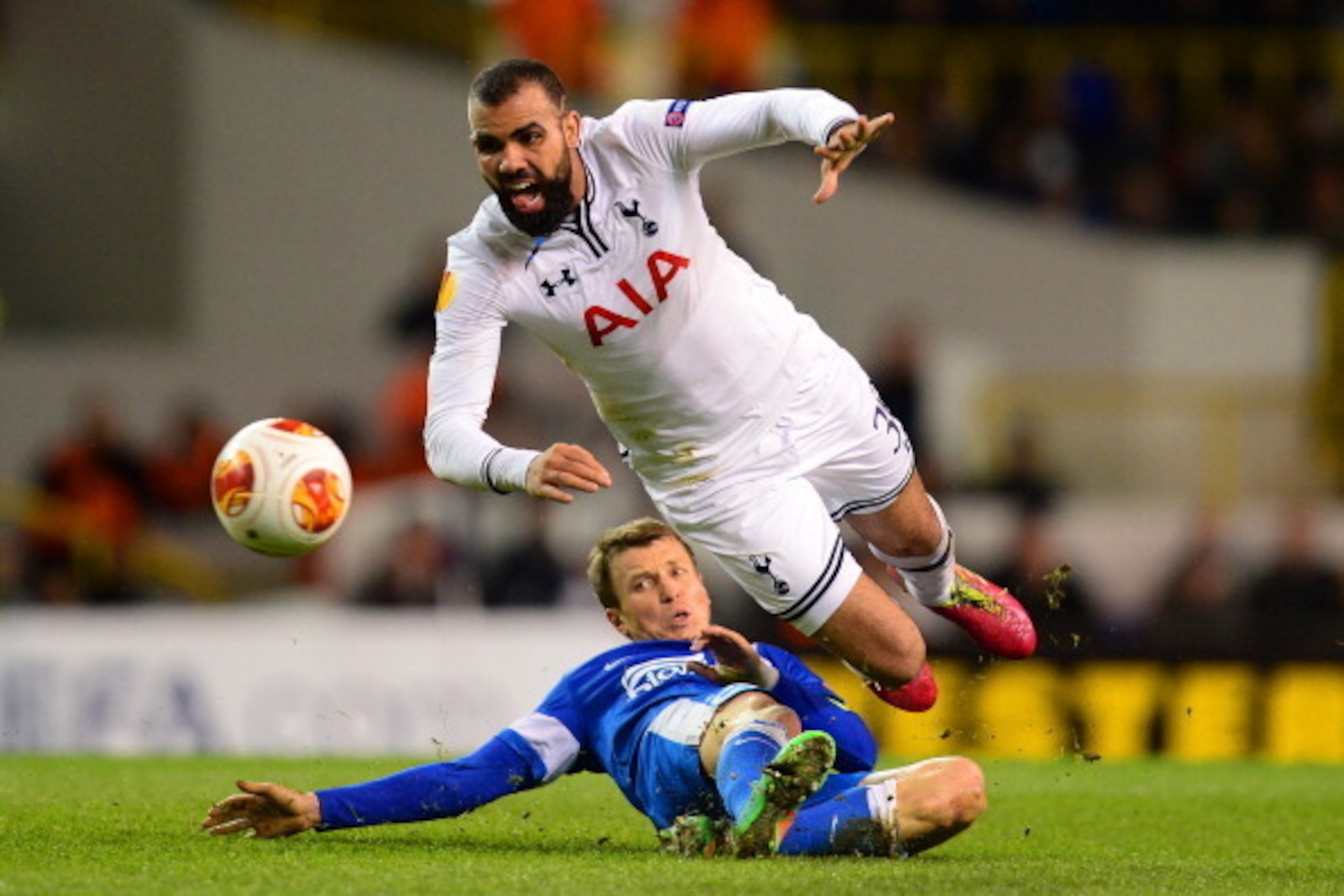 LONDON, ENGLAND - FEBRUARY 27:  Ruslan Rotan of Dnipro Dnipropetrovsk tackles Sandro of Tottenham Hotspur during the UEFA Europa League Round of 32 second leg match between Tottenham Hotspur and  FC Dnipro Dnipropetrovsk at White Hart Lane on February 27,