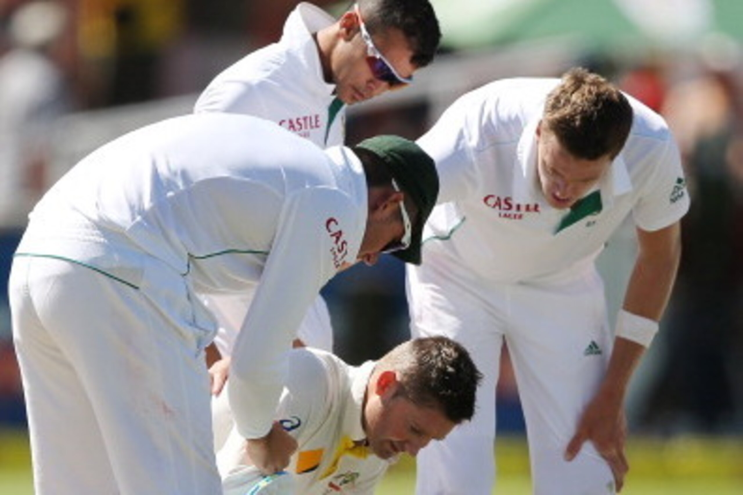 CAPE TOWN, SOUTH AFRICA - MARCH 01:  Michael Clarke of Australia goes down after getting hit by a delivery from Morne Morkel of South Africa during day one of the third test match between South Africa and Australia at Newlands cricket ground on March 1, 2