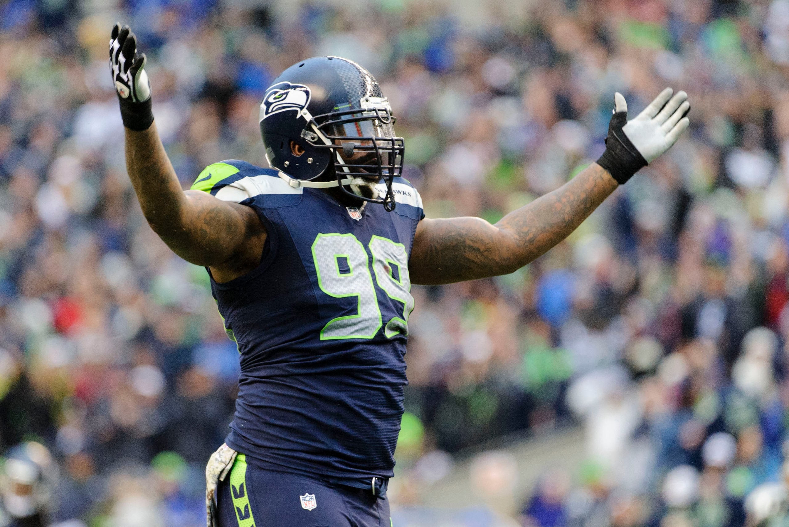Nov 17, 2013; Seattle, WA, USA; Seattle Seahawks defensive tackle Tony McDaniel (99) celebrates after the Seattle Seahawks middle linebacker Bobby Wagner (54) (not pictured) intercepted the ball against the Minnesota Vikings during the second half at Cent