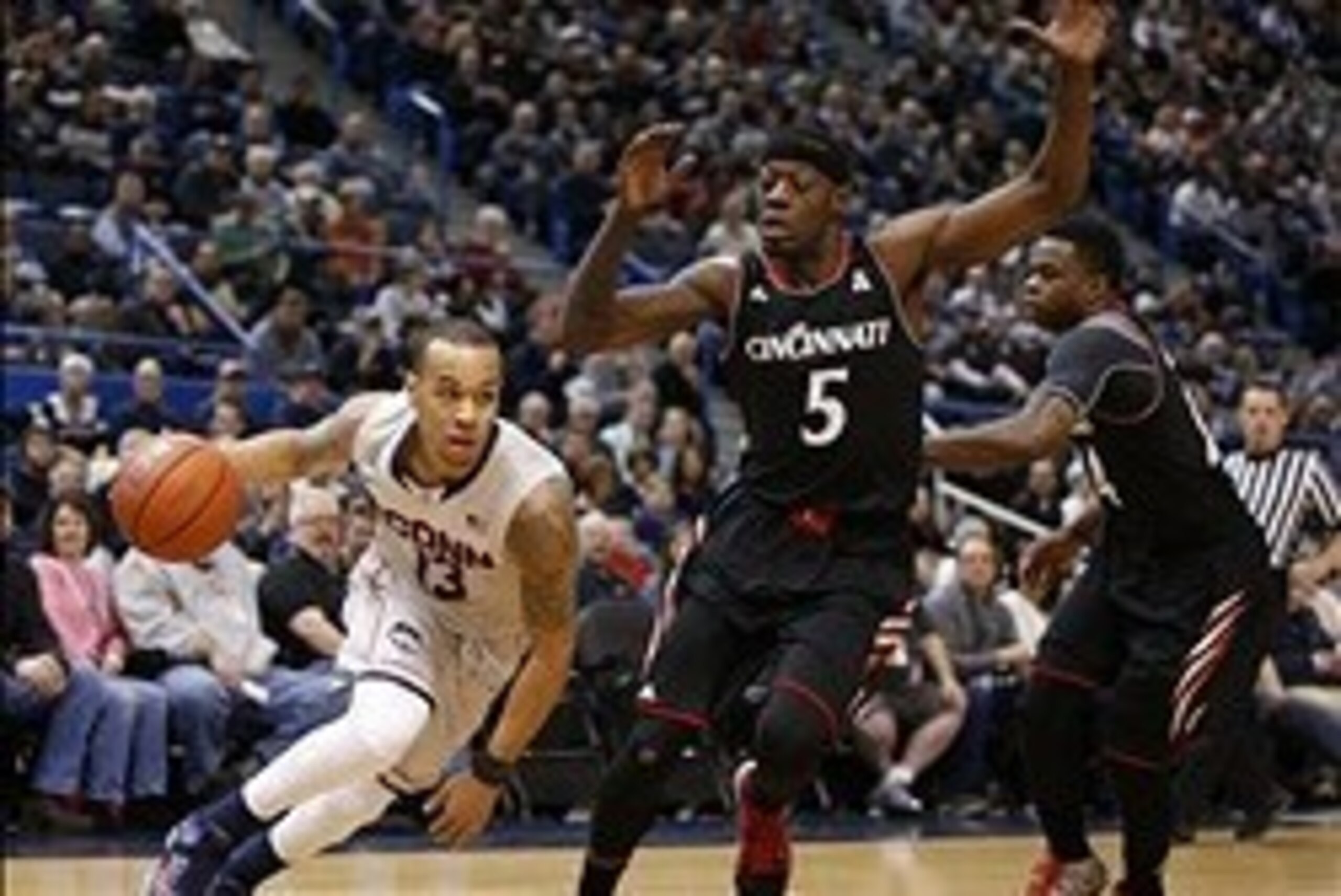 Mar 1, 2014; Hartford, CT, USA; Connecticut Huskies guard Shabazz Napier (13) drives the ball against Cincinnati Bearcats forward Justin Jackson (5) in the first half at XL Center. Mandatory Credit: David Butler II-USA TODAY Sports Mar 1, 2014; Hartford, CT, USA; Connecticut Huskies guard Shabazz Napier (13) drives the ball against Cincinnati Bearcats forward Justin Jackson (5) in the first half at XL Center. Mandatory Credit: David Butler II-USA TODAY Sports