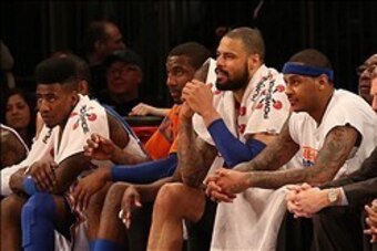 Feb 4, 2013; New York, NY, USA;  New York Knicks point guard Iman Shumpert (21) and power forward Amar'e Stoudemire (1) and center Tyson Chandler (6) and small forward Carmelo Anthony (7) (l to r) watch from the bench during the fourth quarter against the