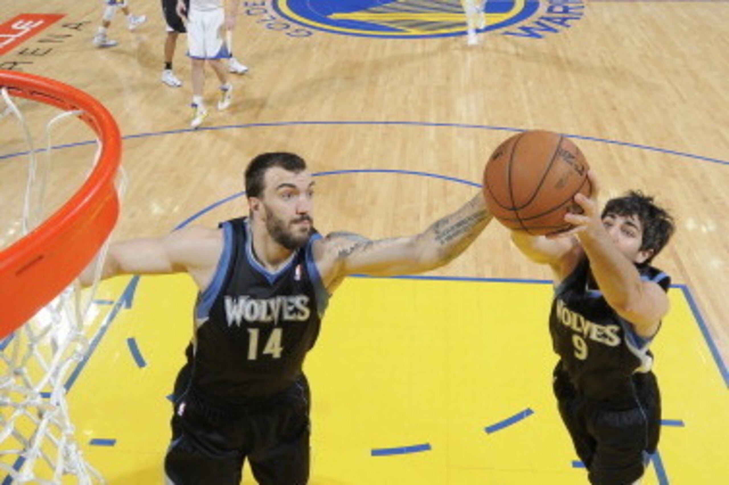 OAKLAND, CA - APRIL 9: Ricky Rubio #9 and Nikola Pekovic #14 of the Minnesota Timberwolves rebound against the Golden State Warriorson April 9, 2013 at Oracle Arena in Oakland, California. NOTE TO USER: User expressly acknowledges and agrees that, by down
