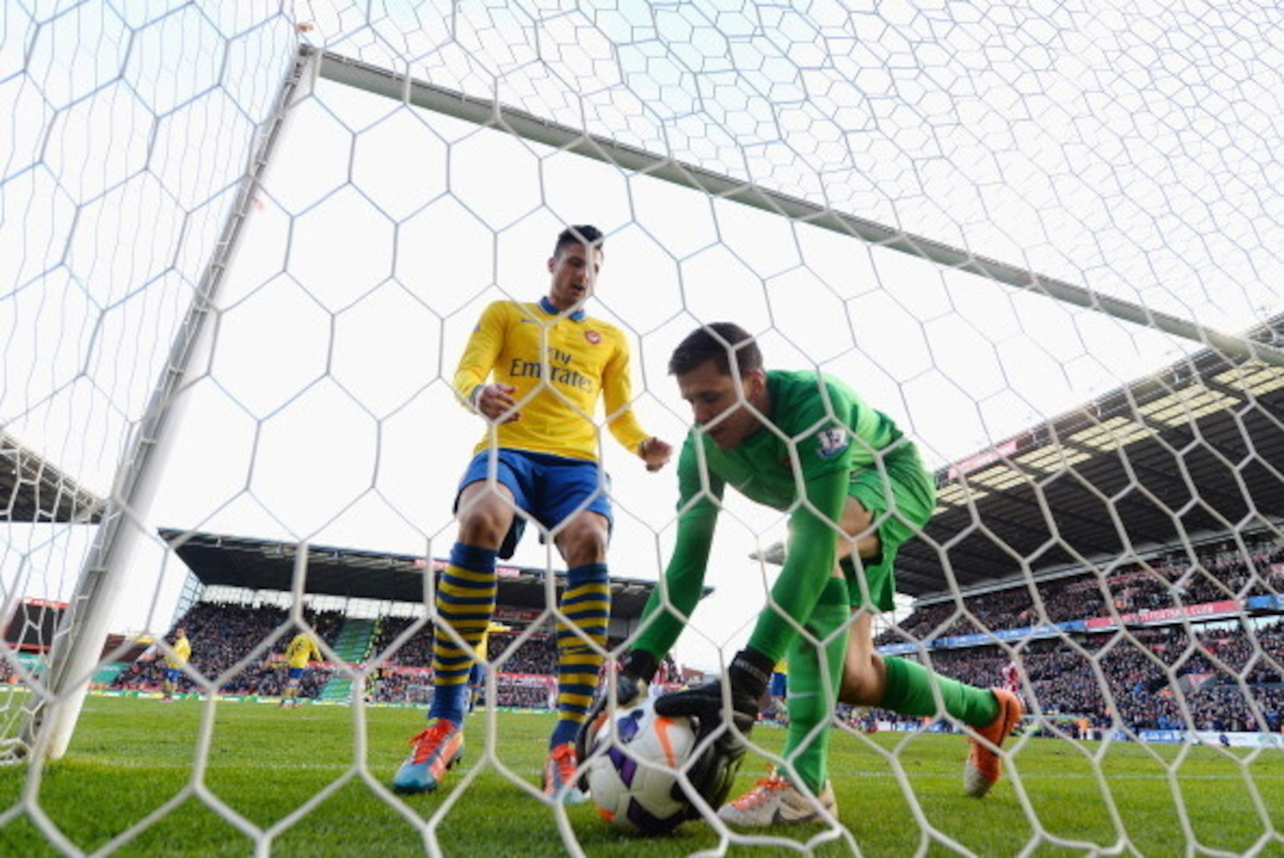 STOKE ON TRENT, ENGLAND - MARCH 01:  Wojciech Szczesny and Olivier Giroud of Arsenal collect the ball from the back of the net after jonathan Walters scores a penalty during the Barclays Premier League match between Stoke City and Arsenal at Britannia Sta