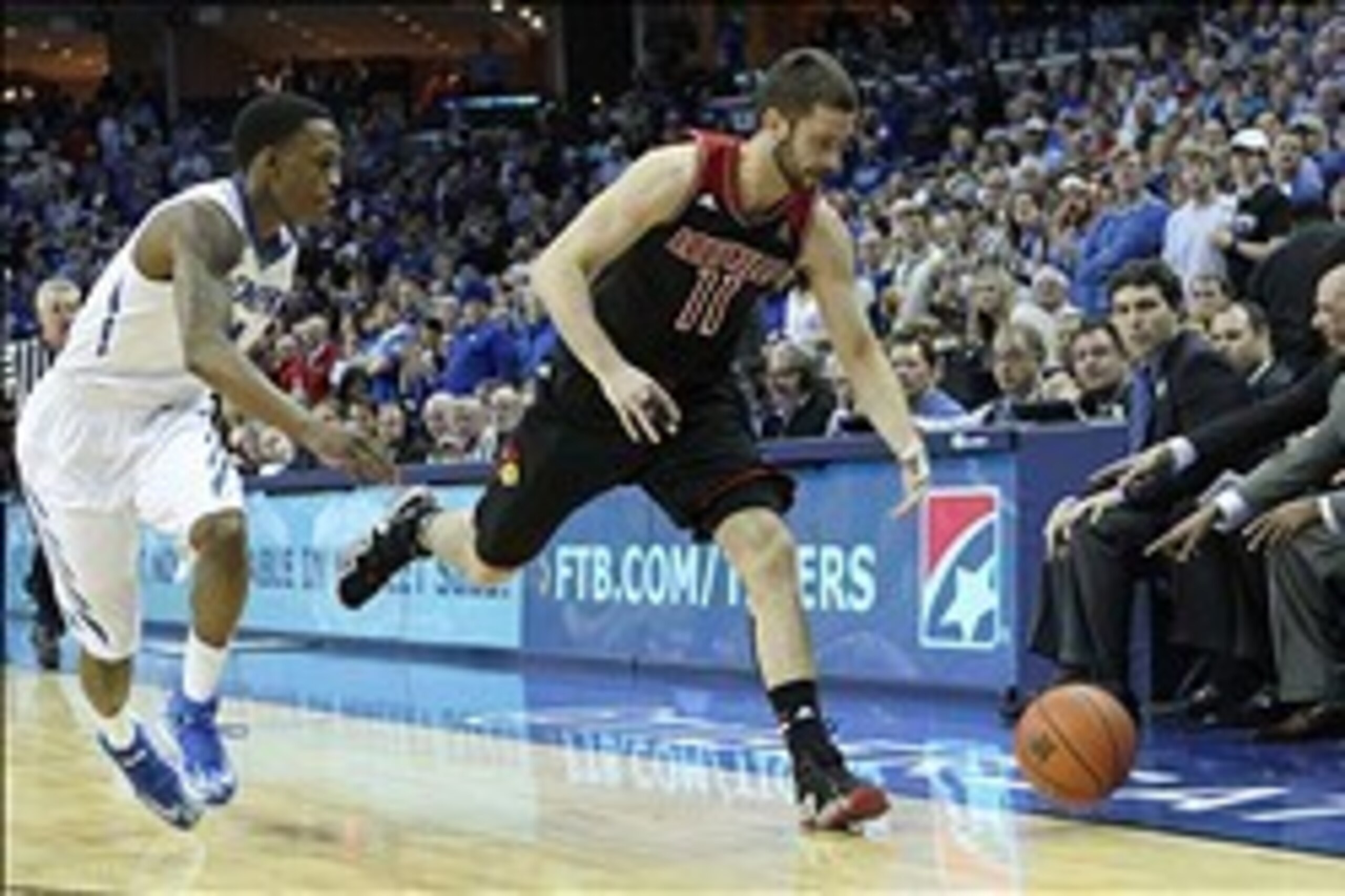 Mar 1, 2014; Memphis, TN, USA; Louisville Cardinals forward Luke Hancock (11) loses the ball out of bounds defended by Memphis Tigers guard Joe Jackson (1) during the first half at FedExForum. Mandatory Credit: Nelson Chenault-USA TODAY Sports