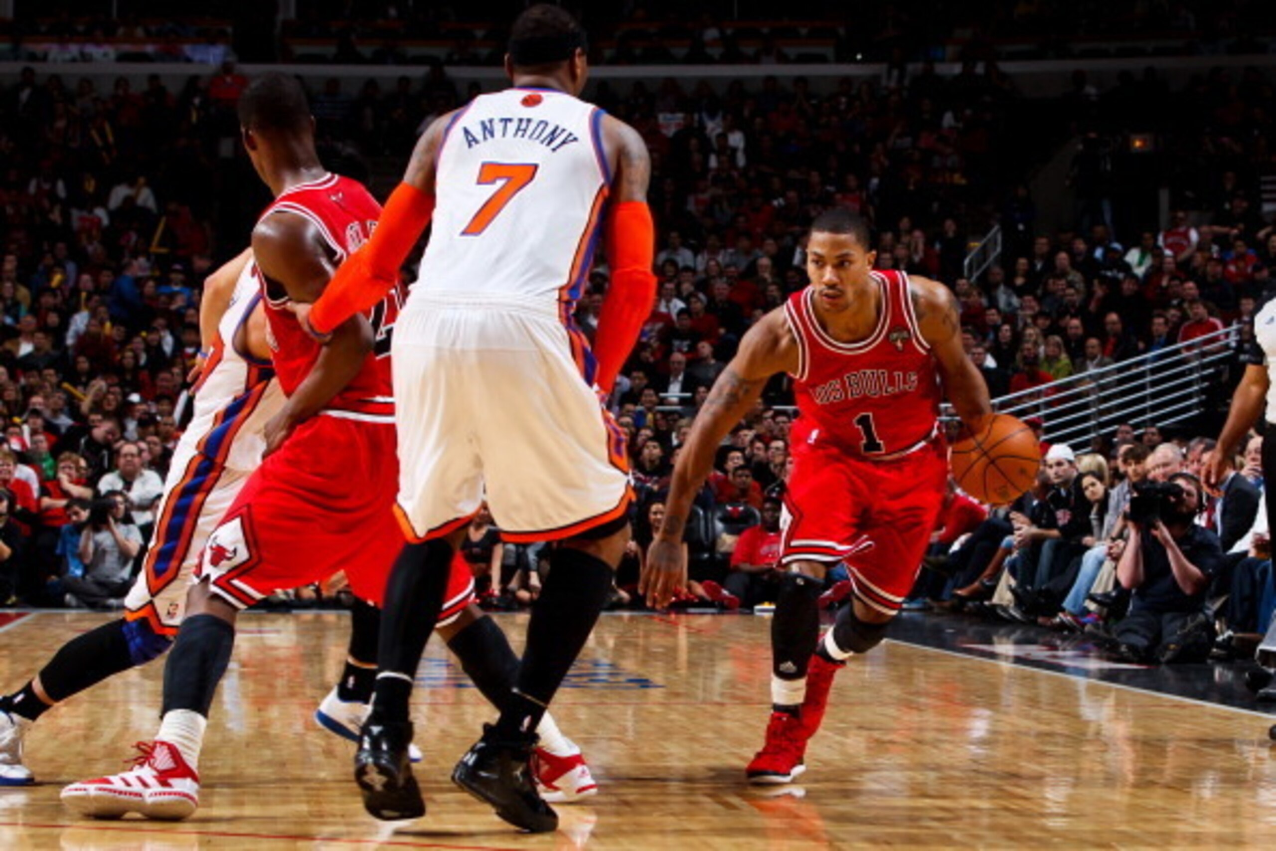 CHICAGO, IL - MARCH 12: Derrick Rose #1 of the Chicago Bulls drives on a screen by teammate Jimmy Butler #21 against Carmelo Anthony #7 and Jeremy Lin #17 of the New York Knicks on March 12, 2012 at the United Center in Chicago, Illinois. NOTE TO USER:  U